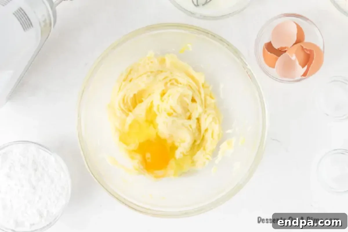 Eggs being beaten into the butter and sugar mixture.