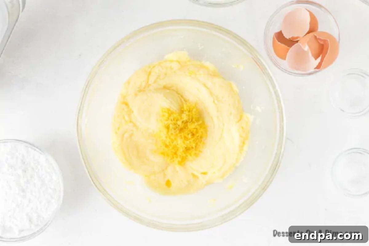 Lemon zest being stirred into the cake batter.