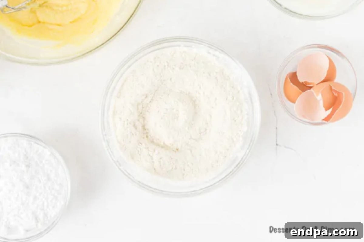 Dry ingredients being added alternately with wet ingredients to the main batter.
