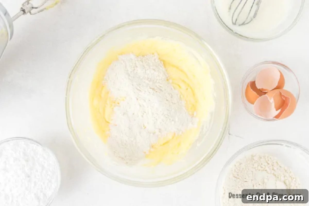 Fully mixed cake batter spread into a loaf pan, ready for baking.