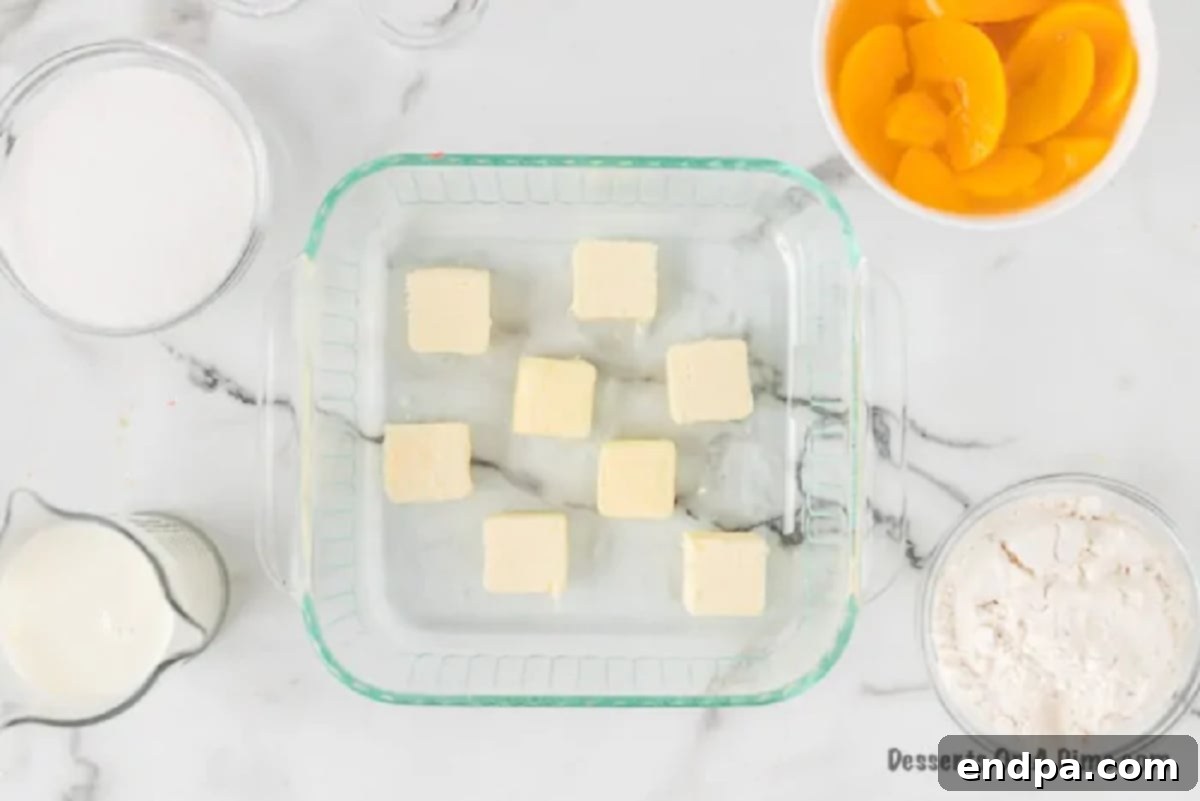 Slices of butter arranged in a baking dish, ready to be melted in the oven.
