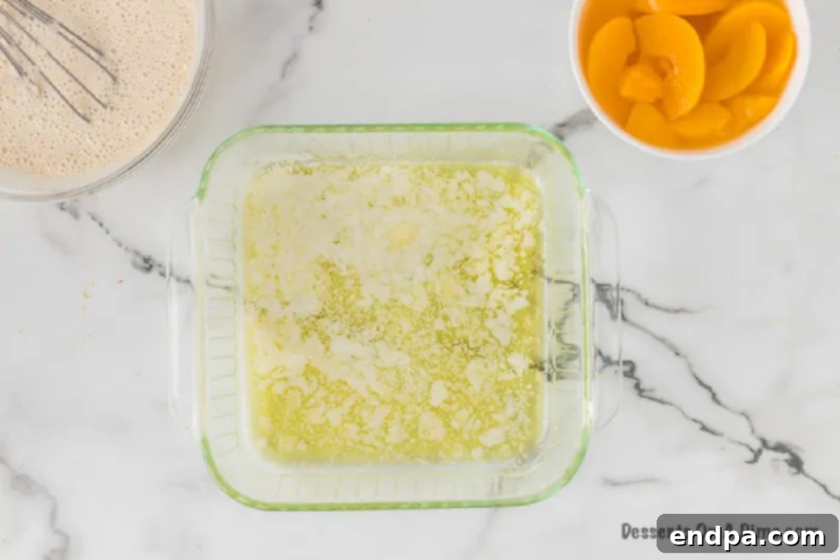 Melted butter coating the bottom of a baking dish, ready for the next step.