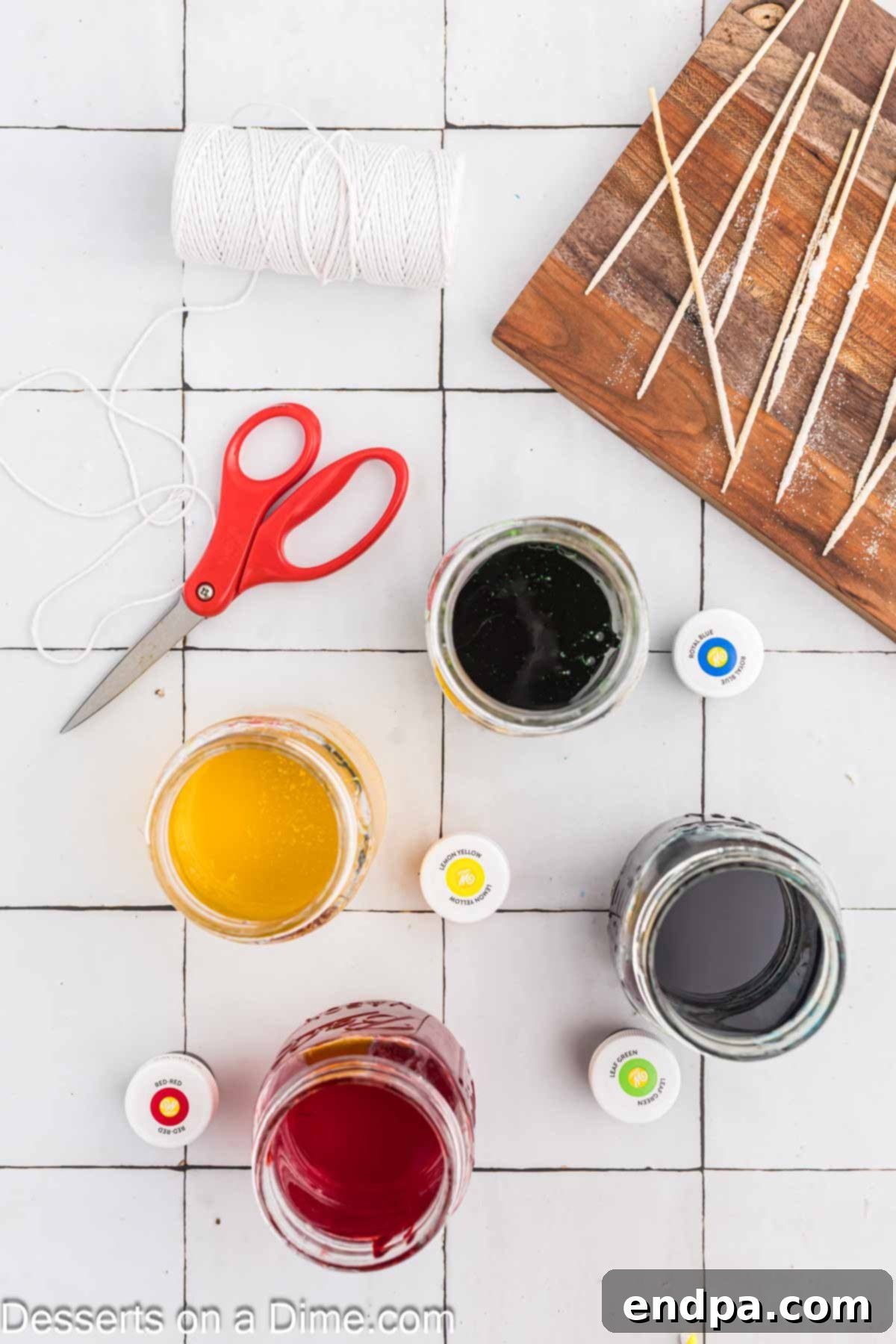 Growing Sweet Rock Candy Crystals 8 Food coloring being added to jars of sugar solution with a dropper.