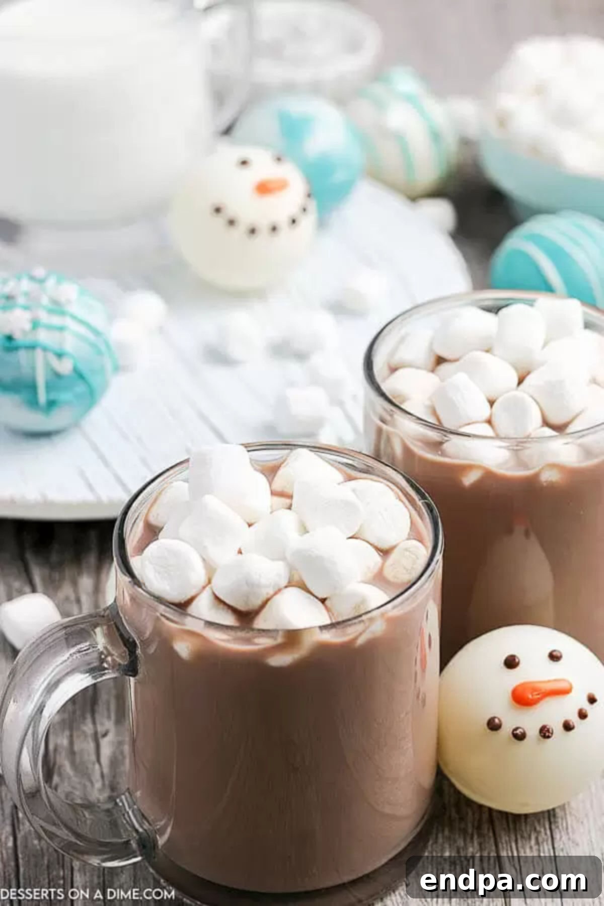Clear mug filled with hot chocolate and topped with a generous amount of mini marshmallows, ready to be enjoyed.