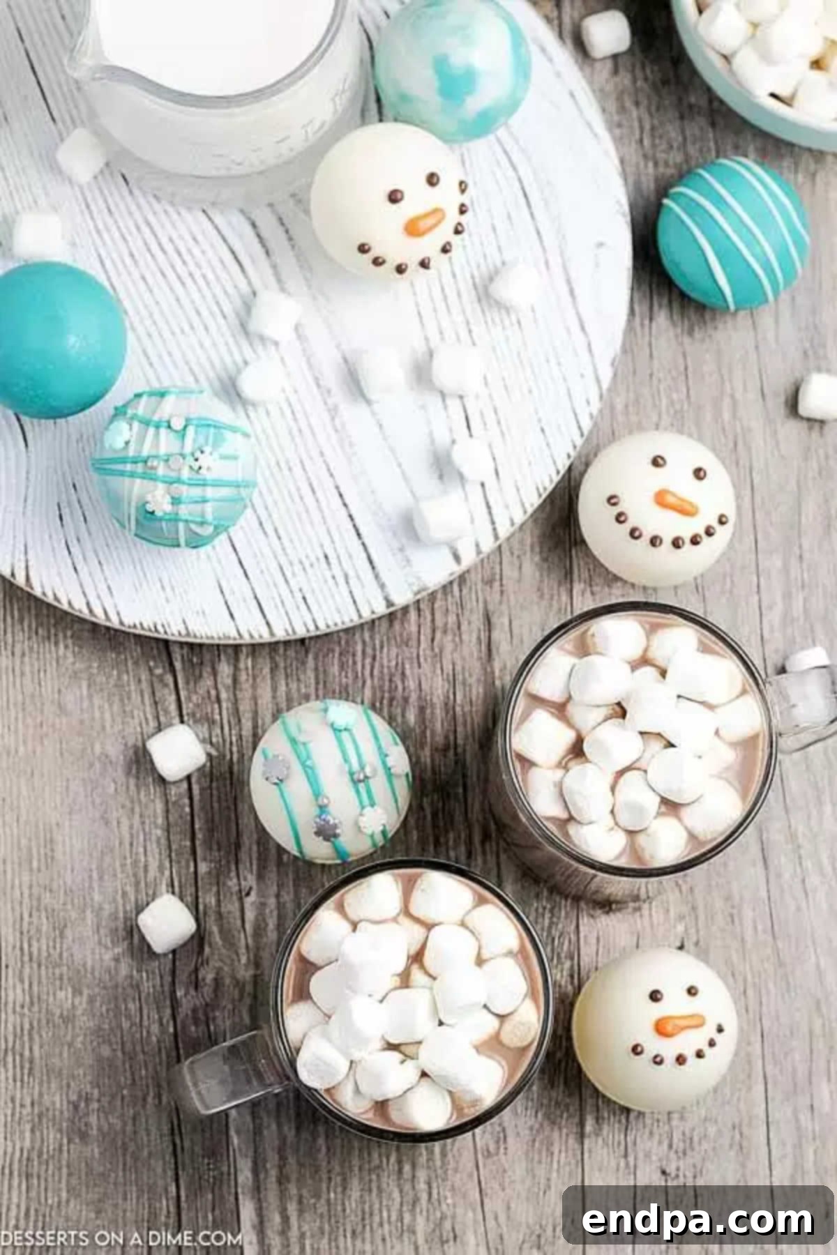 Clear mug with hot chocolate topped with fluffy white marshmallows, ready to be enjoyed.