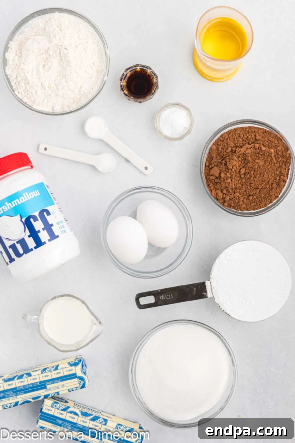 Ingredients for whoopie pie recipe - flour, cocoa, baking soda, eggs, milk, butter, marshmallow fluff.