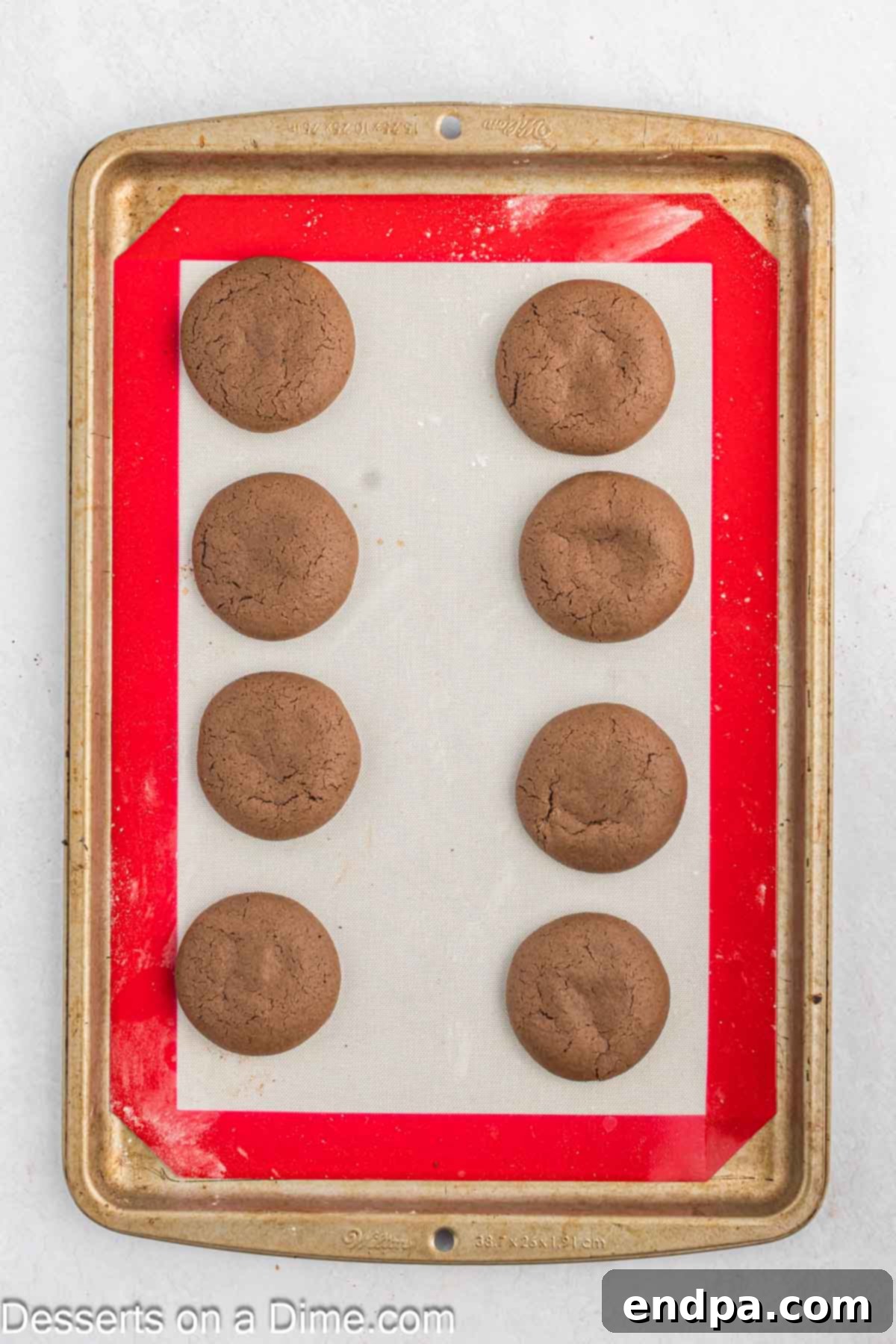 Cookies baked and cooling on cookie sheet.
