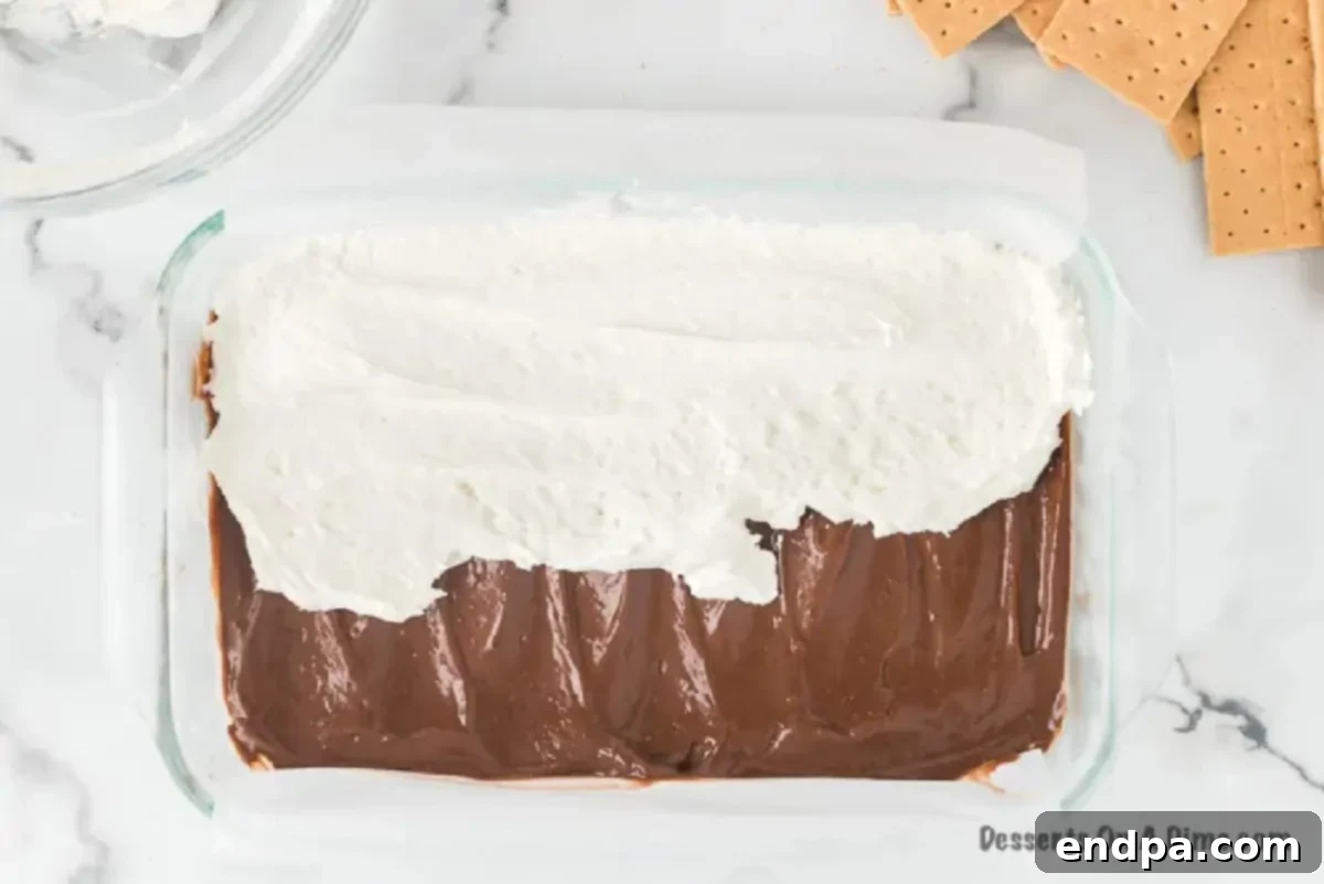Smores Freeze 6 Marshmallow mixture spread smoothly over the chocolate pudding layer in the pan.