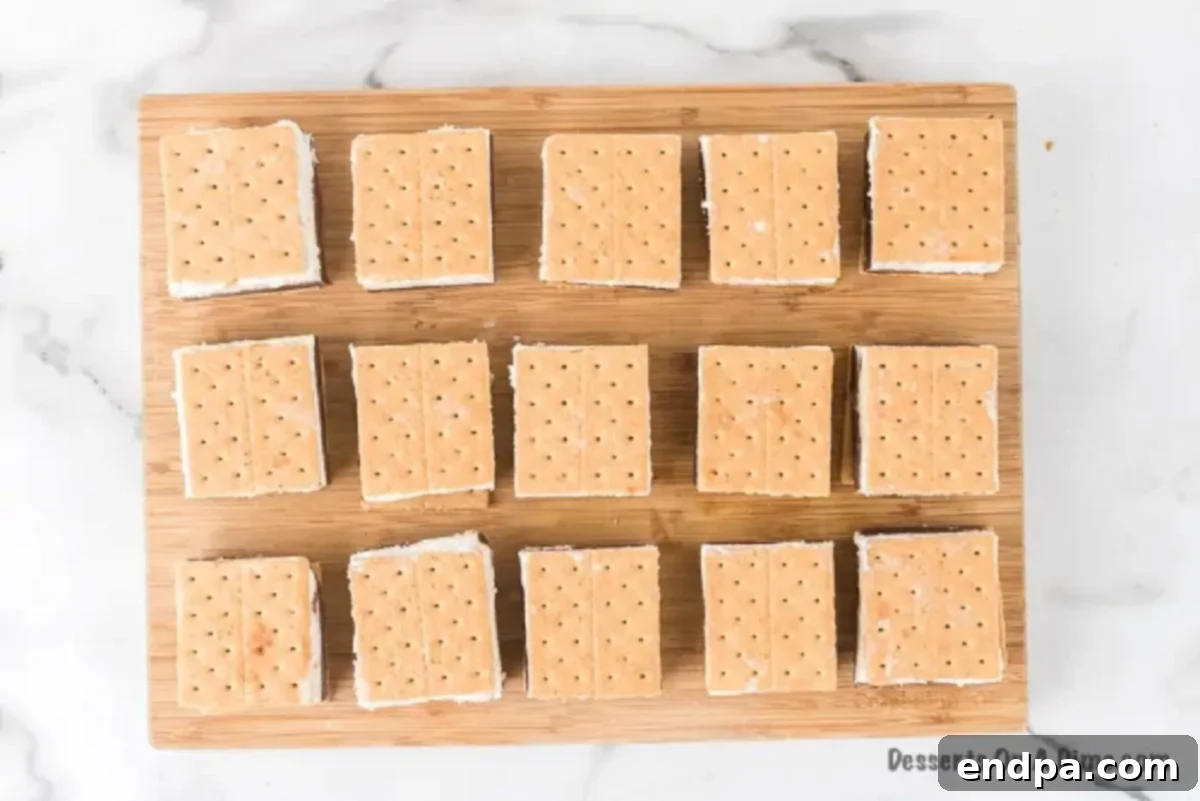 Smores Freeze 9 Individual Frozen S'mores bars on a cutting board, with graham cracker on top.