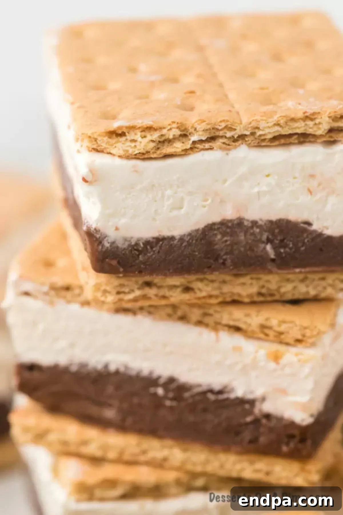 Smores Freeze 10 Frozen S'mores stacked on a plate, showcasing the delicious chilled layers ready to be enjoyed.
