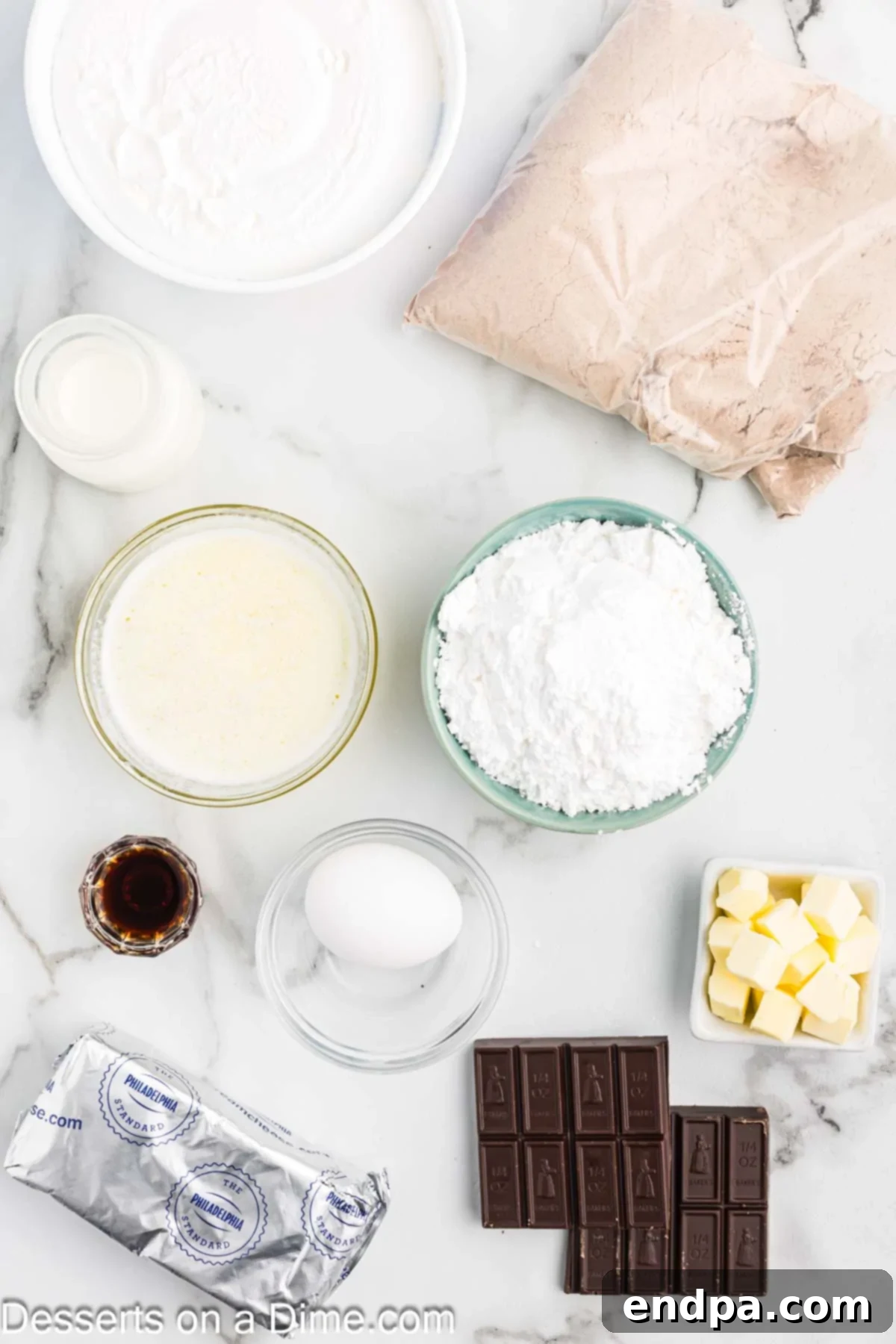 Decadent French Silk Brownies 3 Ingredients for French Silk Brownies - brownie mix, butter, milk, cream cheese, vanilla, confectioners' sugar, chocolate, whipped topping laid out on a surface.