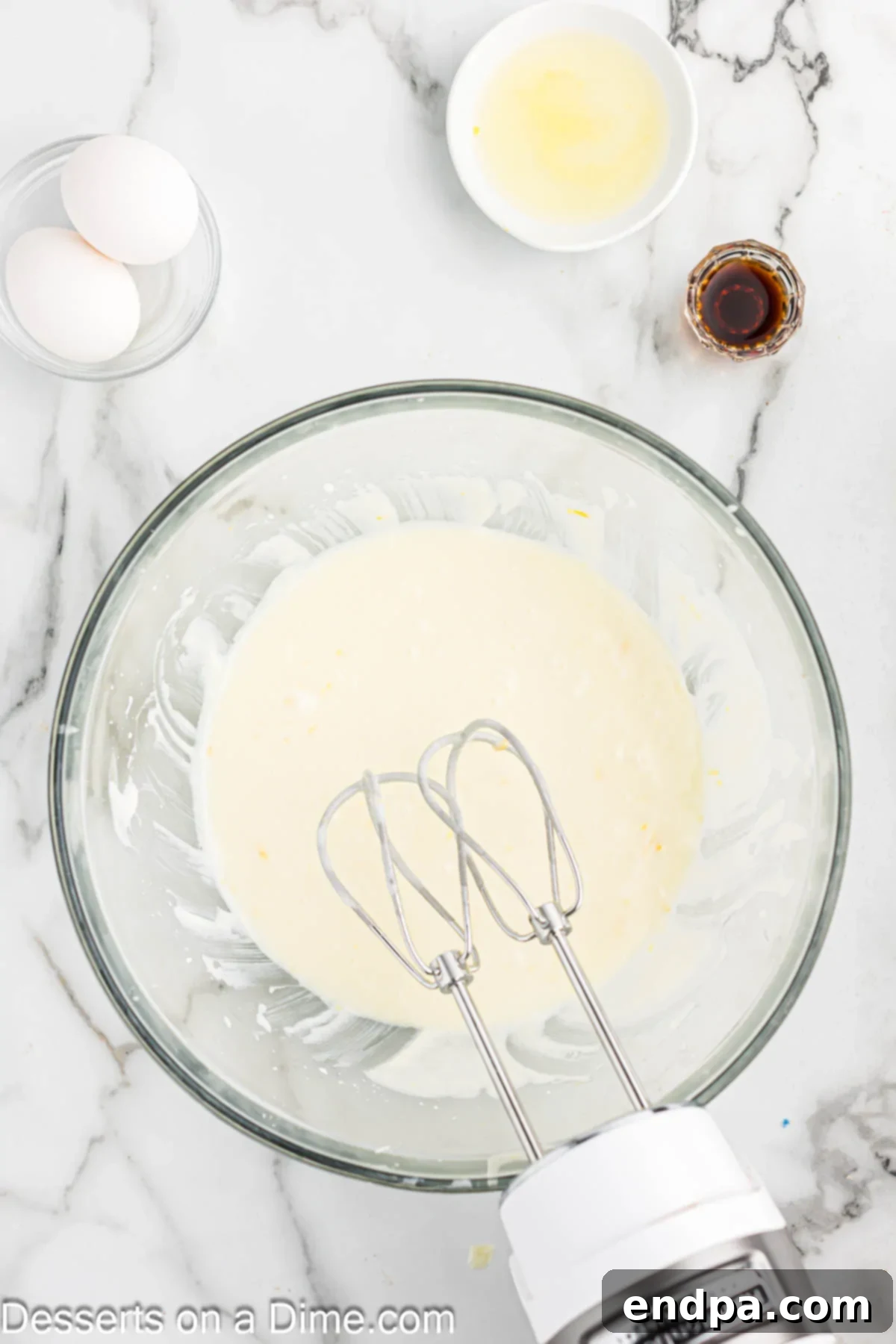 Butter and Greek yogurt added into the sugar mixture in a bowl, being mixed.