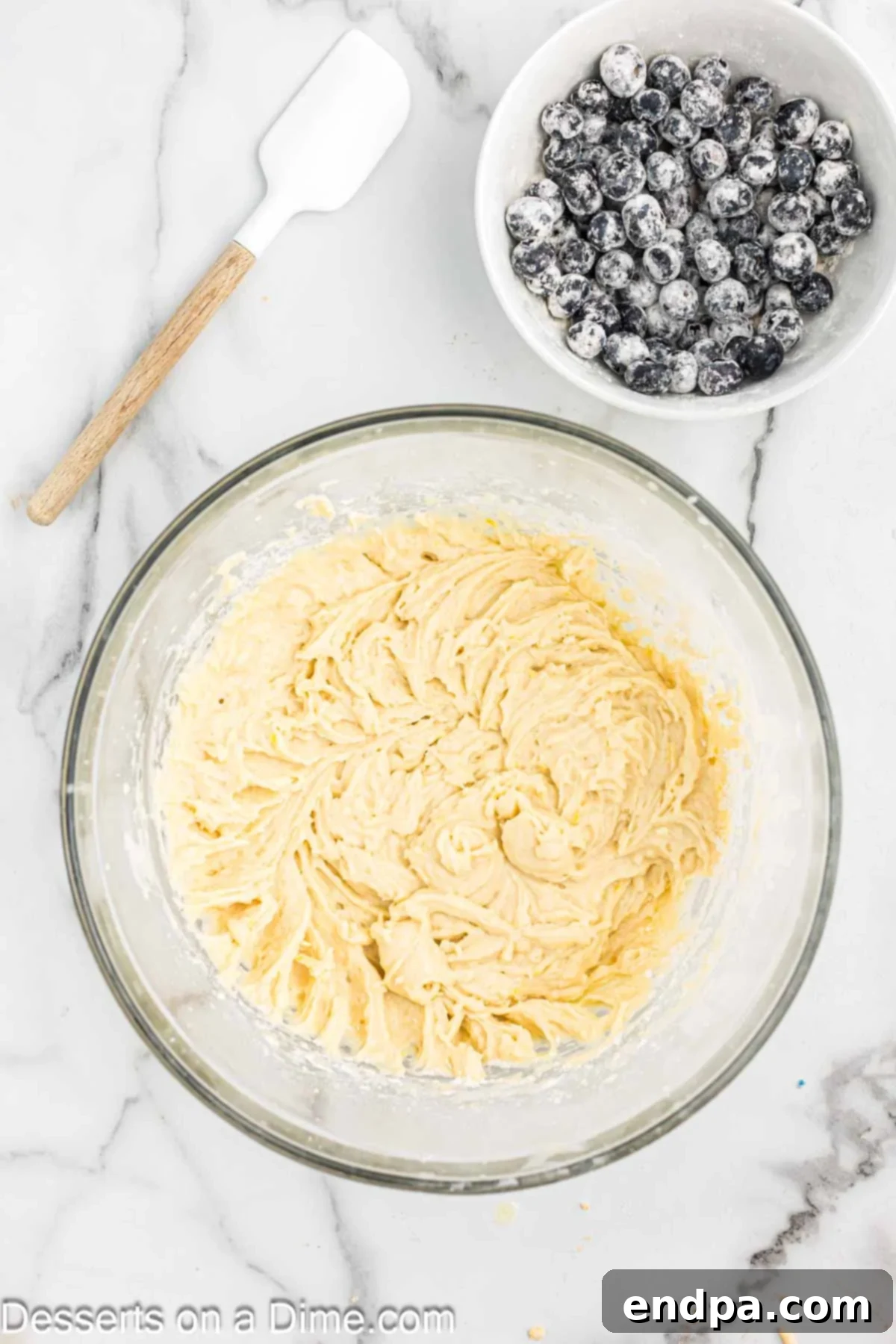 Wet and dry ingredients combined together in a large mixing bowl.