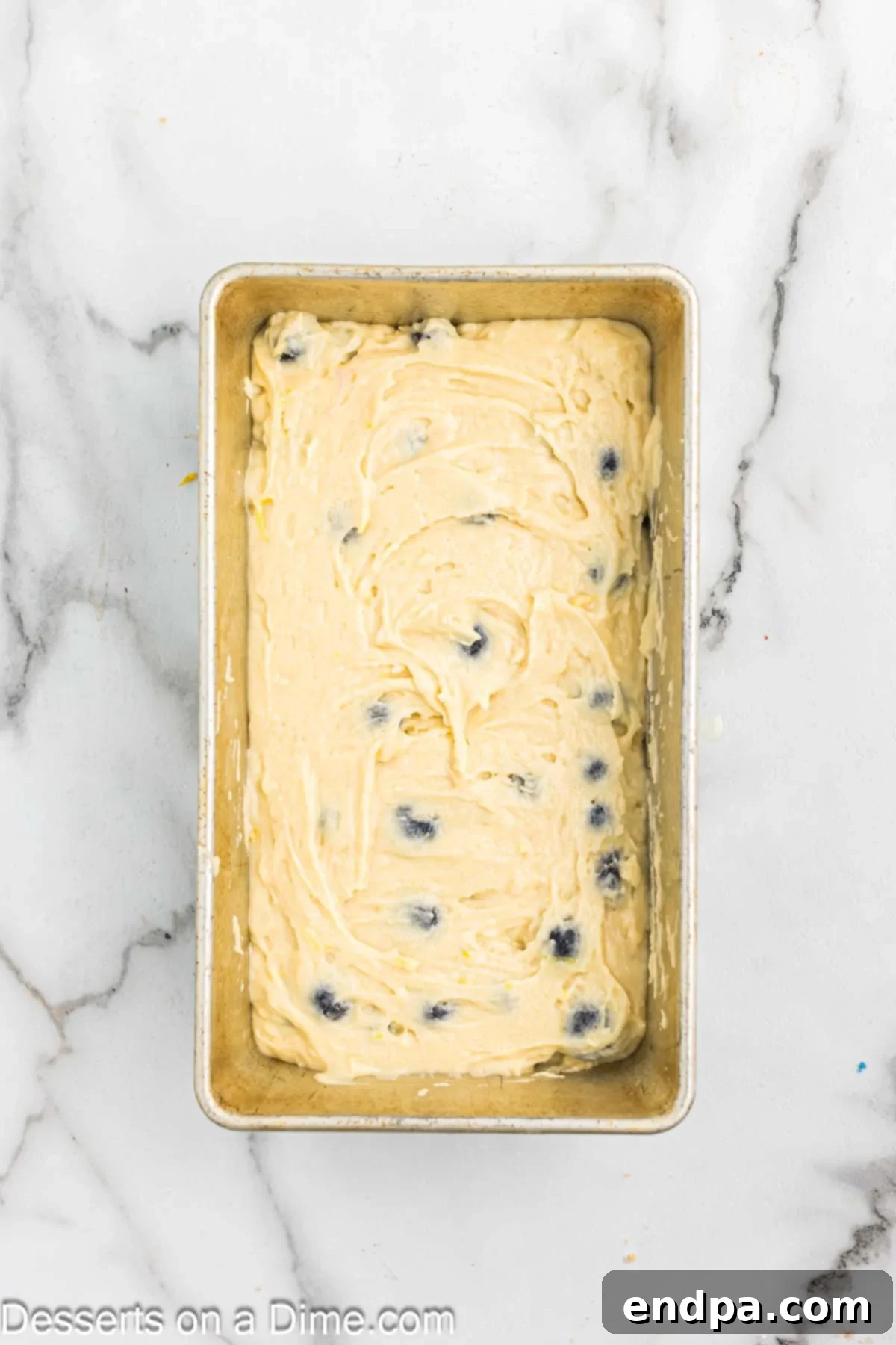 Bread batter poured into the prepared loaf pan.