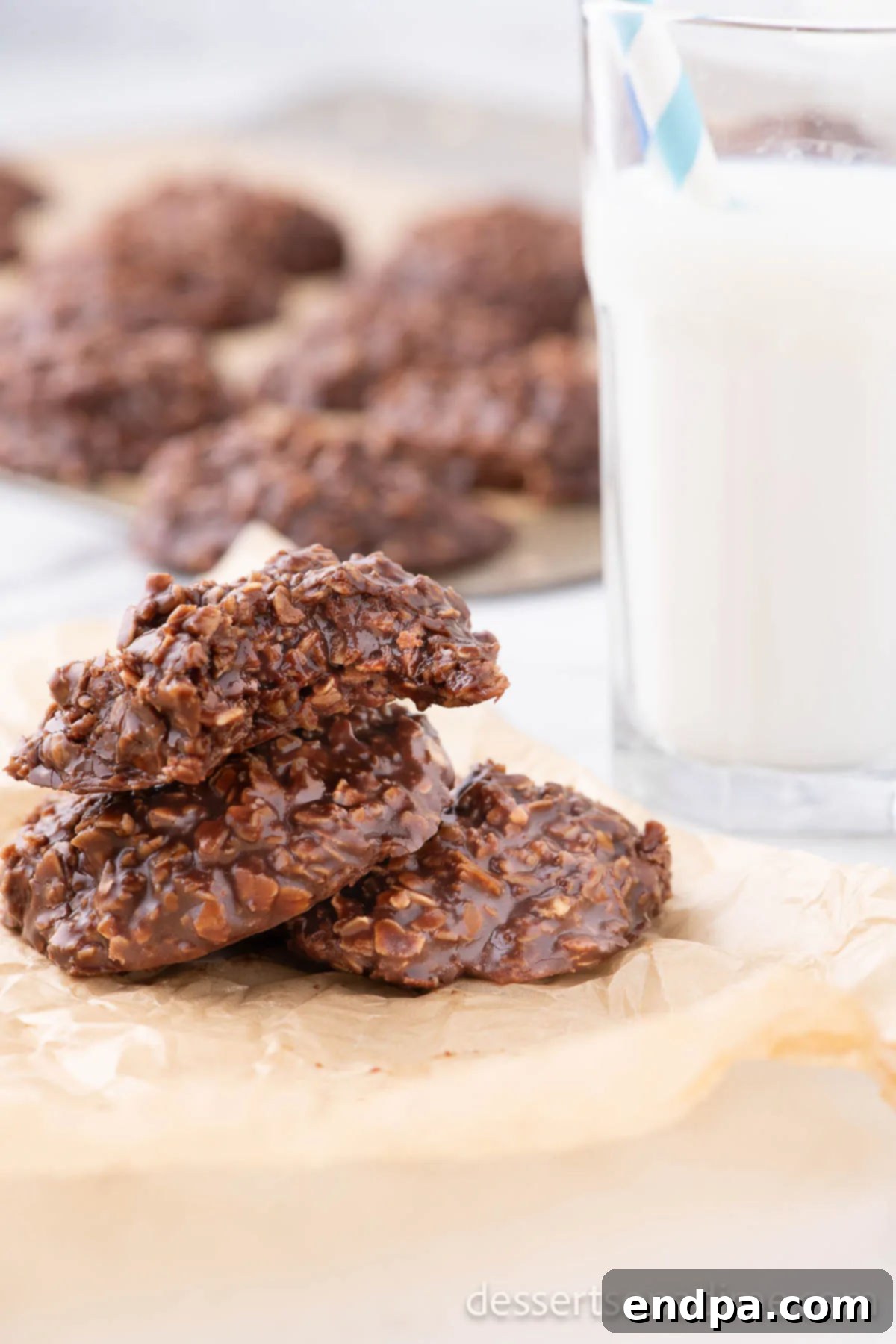 Delicious Nutella No Bake Cookies stacked beside a refreshing glass of milk.