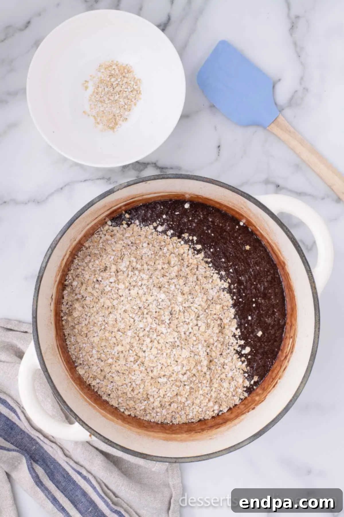 Quick Oats being added to the Nutella and chocolate mixture in the saucepan.