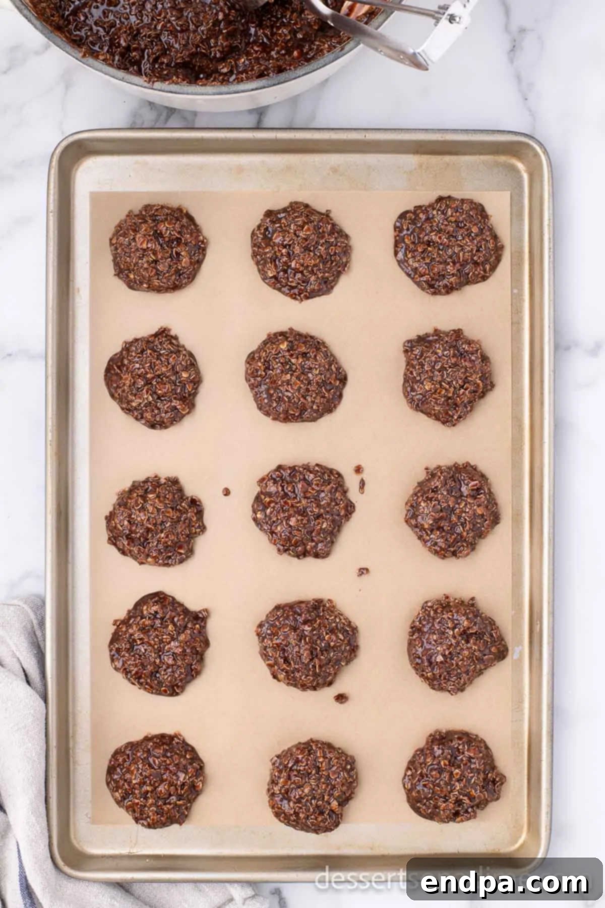 Scooped Nutella No Bake Cookies placed neatly on a parchment-lined baking sheet.