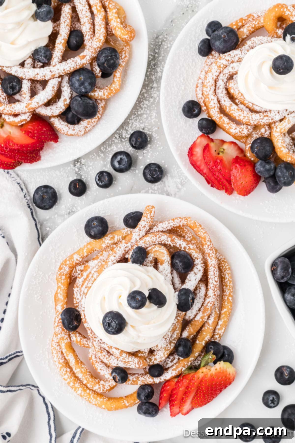 Funnel Cake with whipped cream and berries.