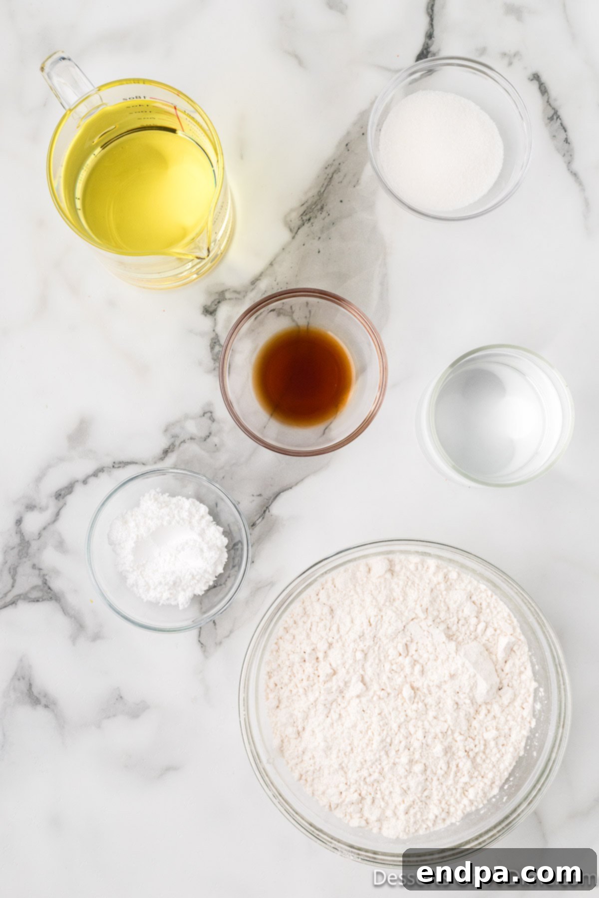 Ingredients for recipe - pancake mix, vanilla, vegetable oil, powdered sugar.
