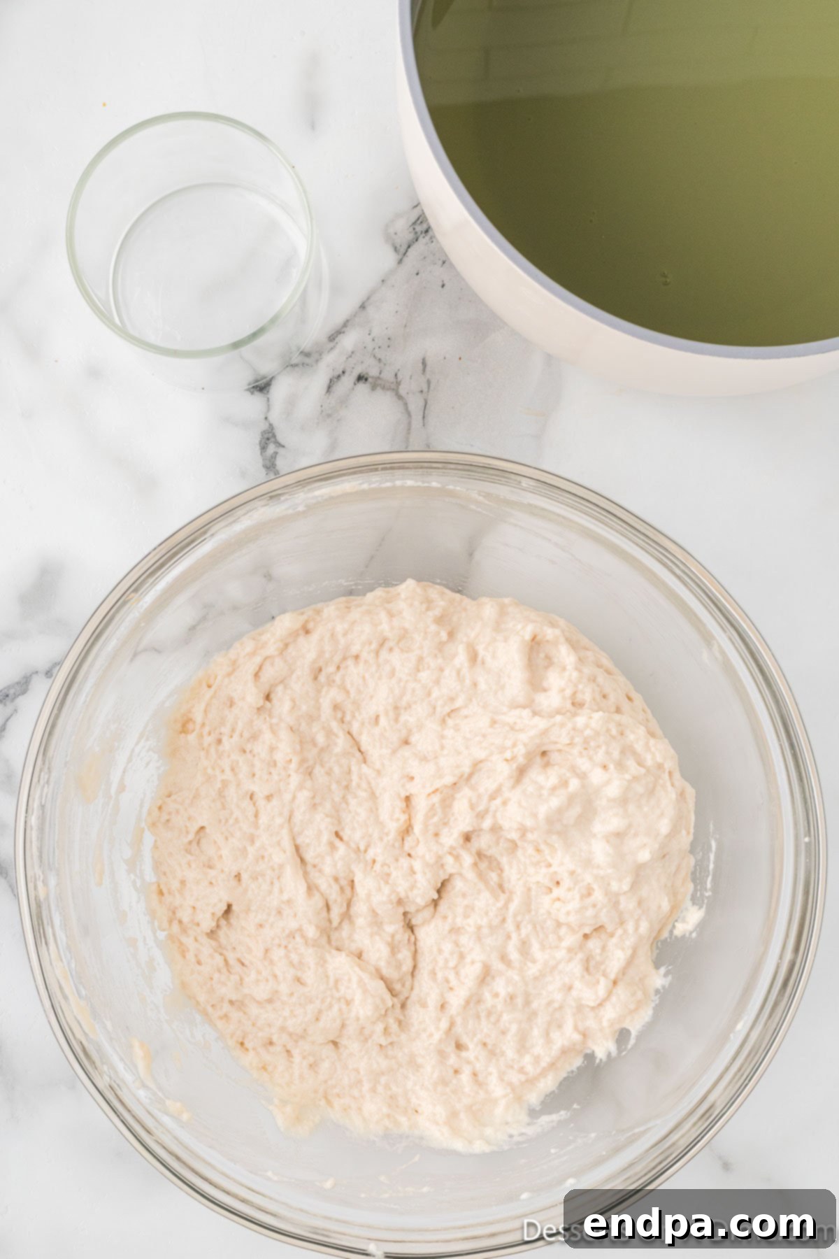 Water gradually added to bowl and combined.