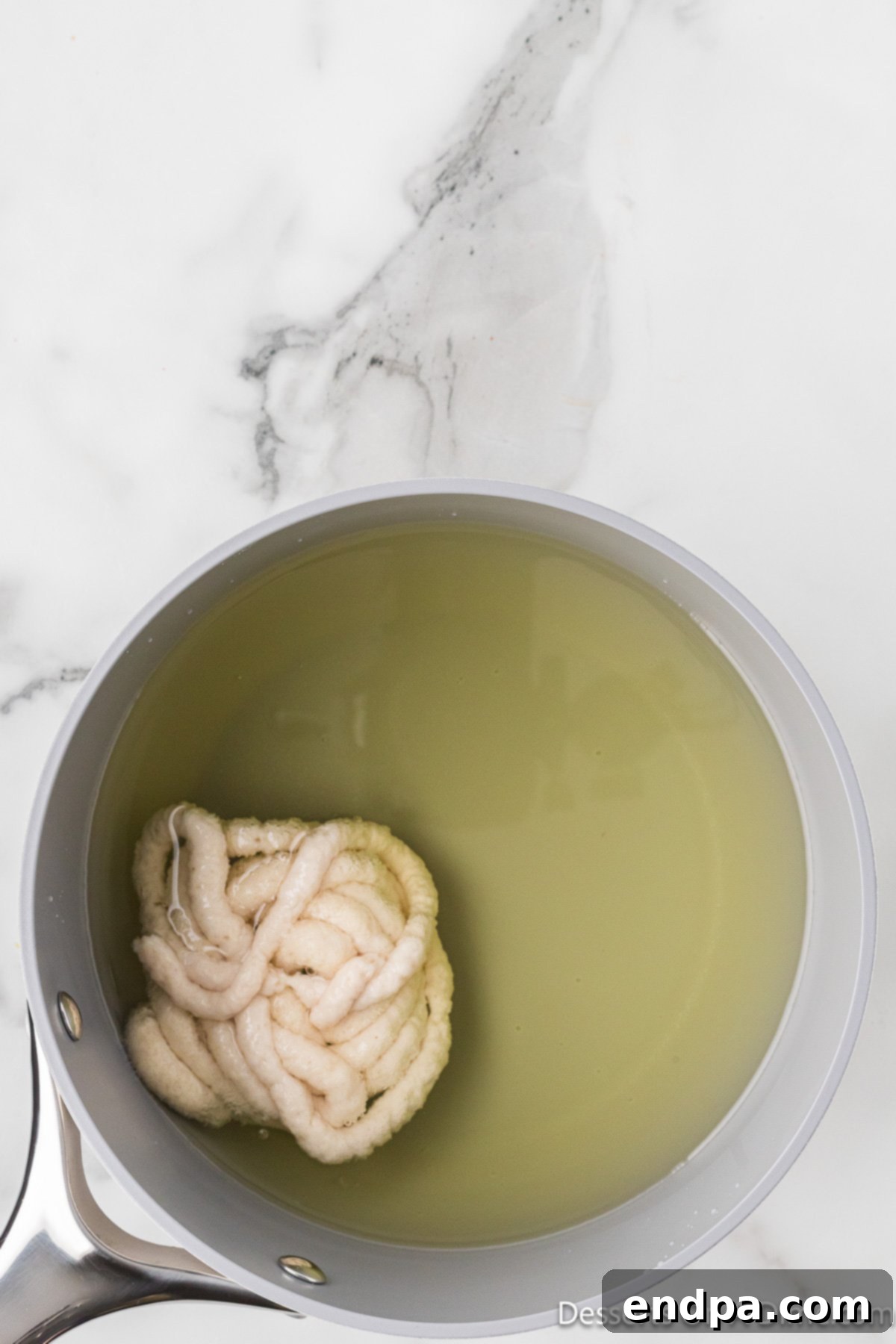 Batter in hot oil frying.