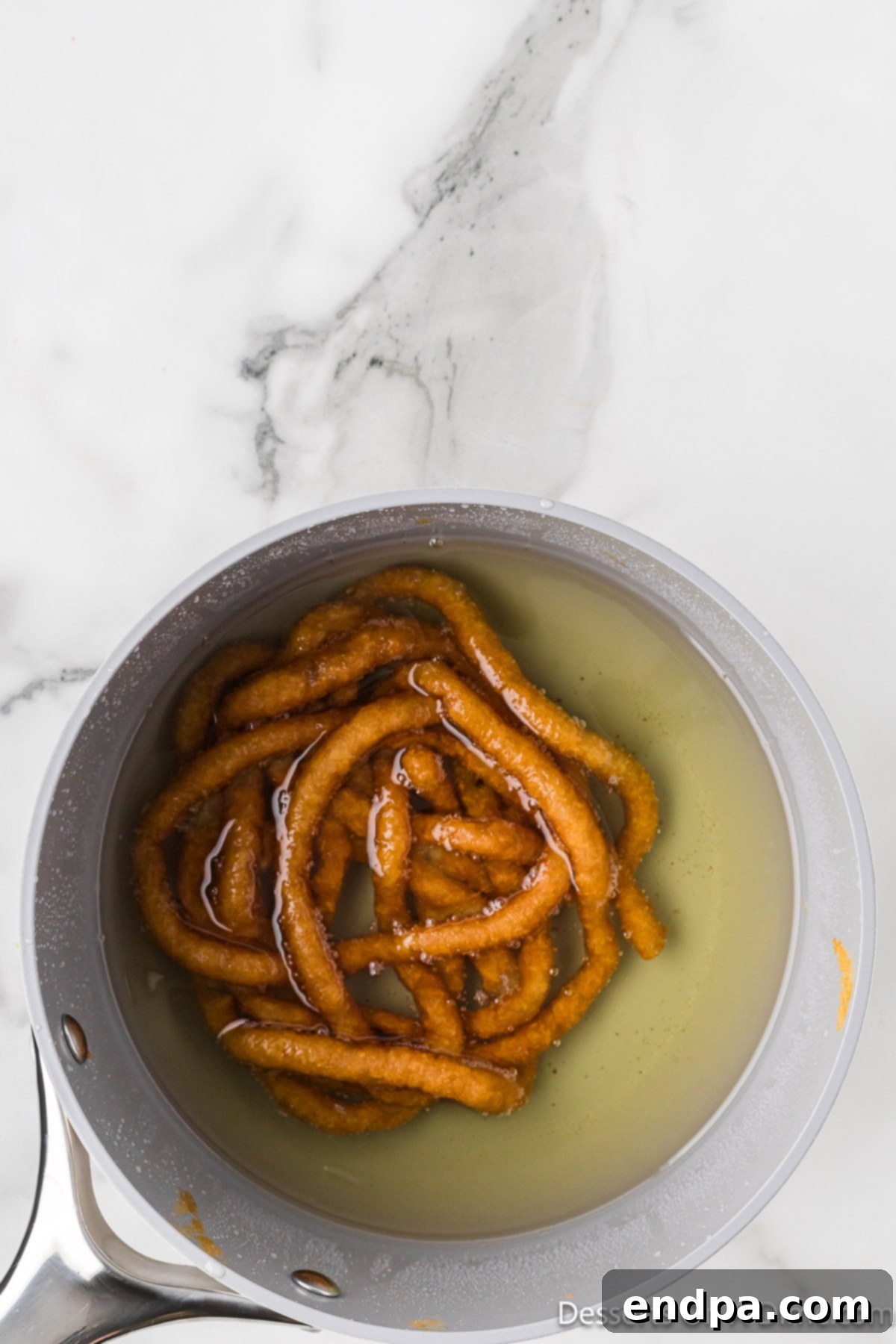 Funnel cake in hot oil.