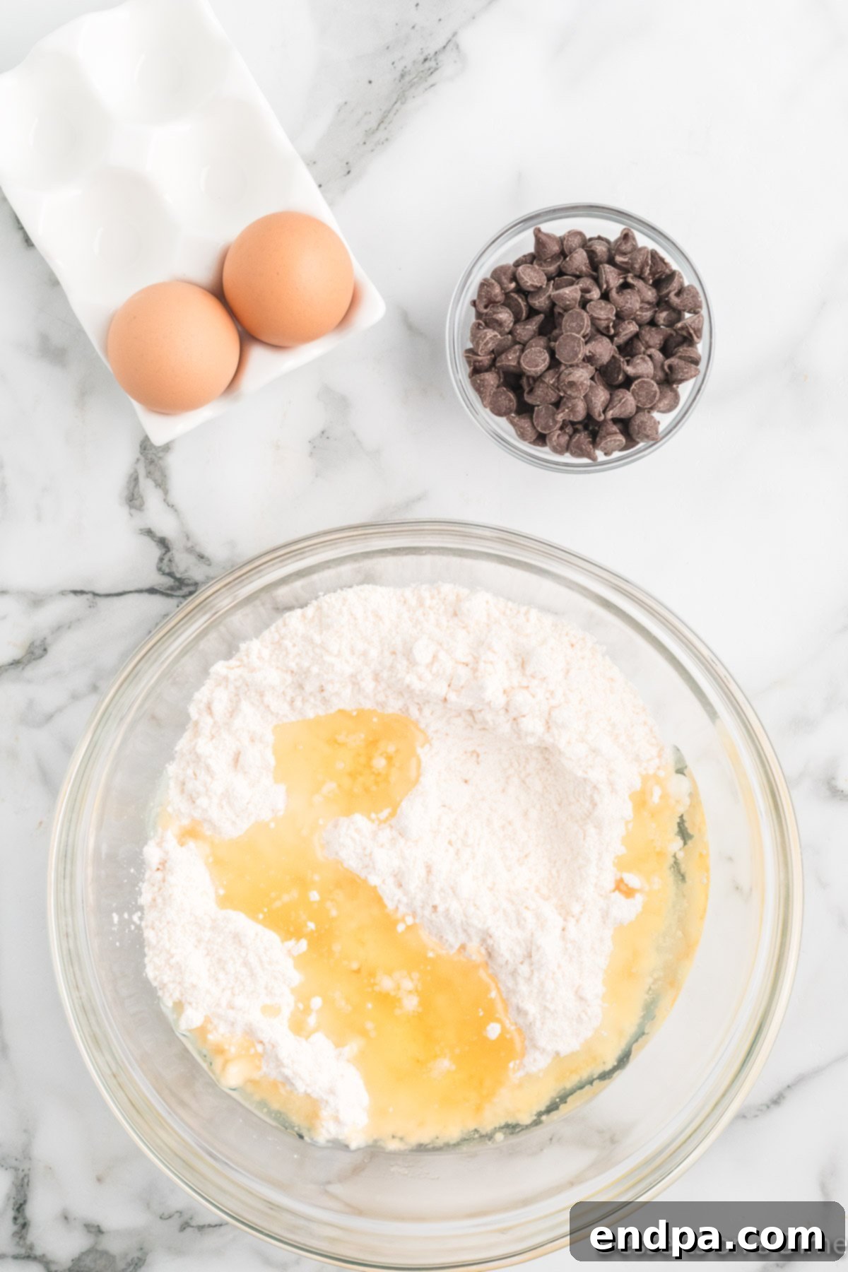 Irresistible Chocolate Chip Cake Mix Cookies 4 Cake mix, oil and eggs in a mixing bowl, ready to be combined.
