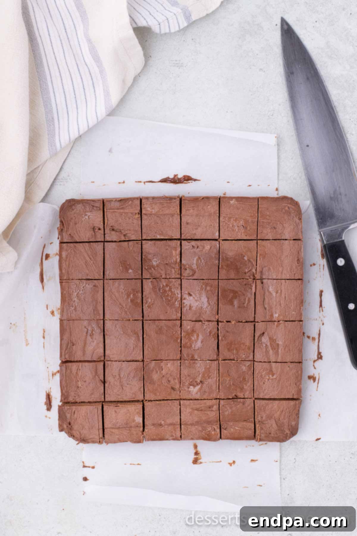 Frozen chocolate mixture cut into neat squares on a cutting board.