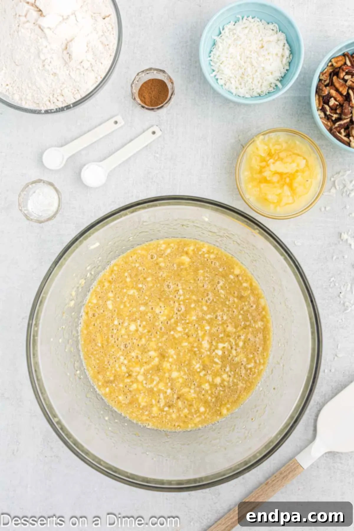 Mixing bowl with mashed bananas, butter and sugars.