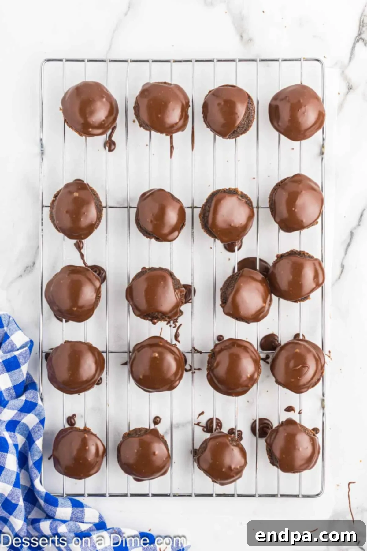 Texas Sheet Cake Minis 11 Finished Texas Sheet Cake Bites with frosting setting on a wire rack.