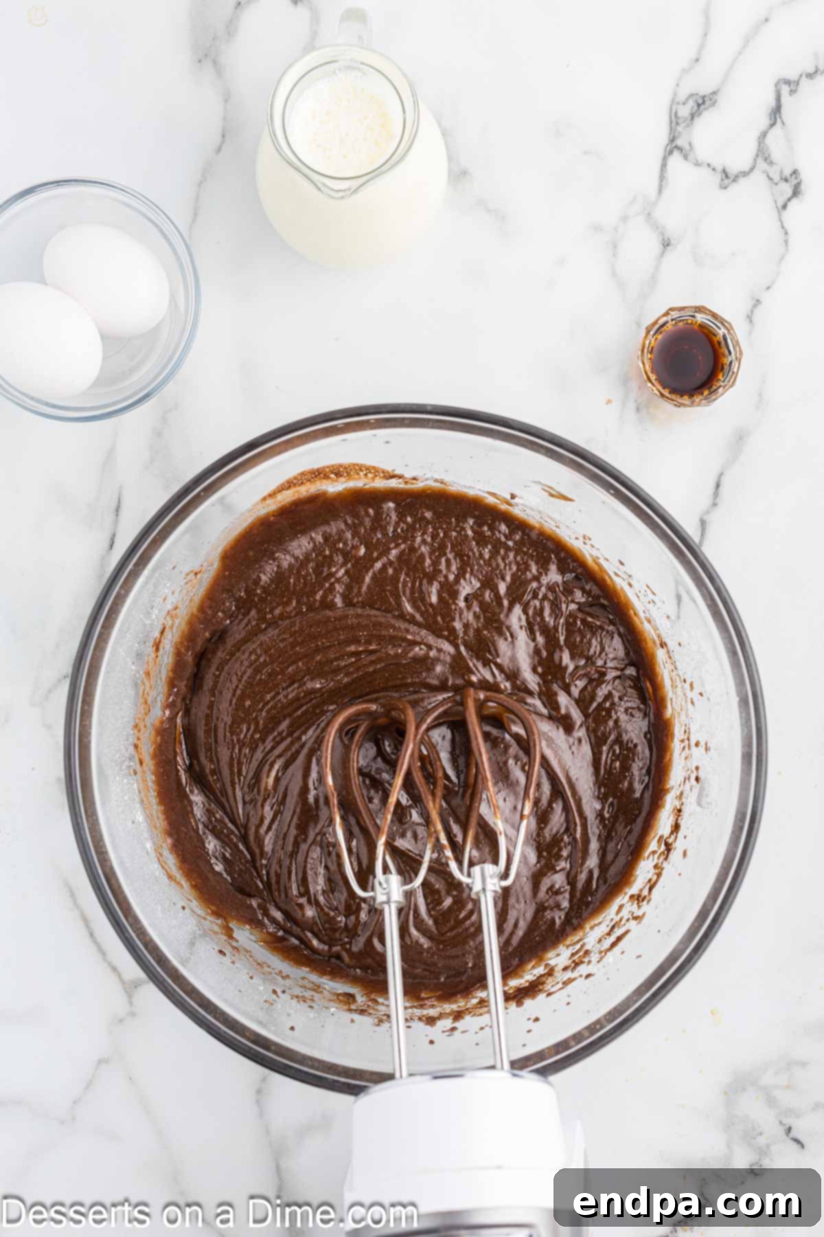 Texas Sheet Cake Minis 5 Wet and dry cake ingredients expertly combined in a large mixing bowl, creating a smooth batter.