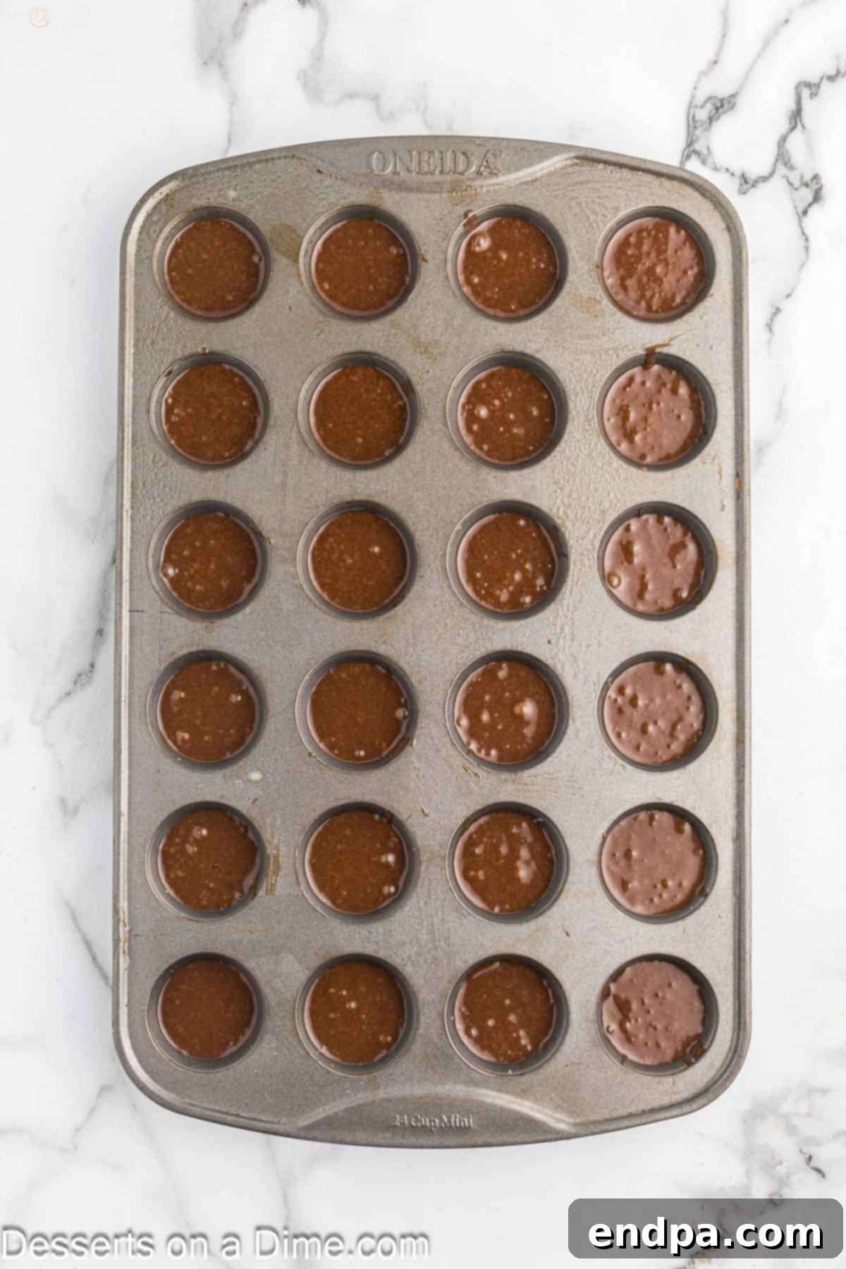 Texas Sheet Cake Minis 7 The thin cake batter being carefully poured into a mini muffin tin, ready for baking.
