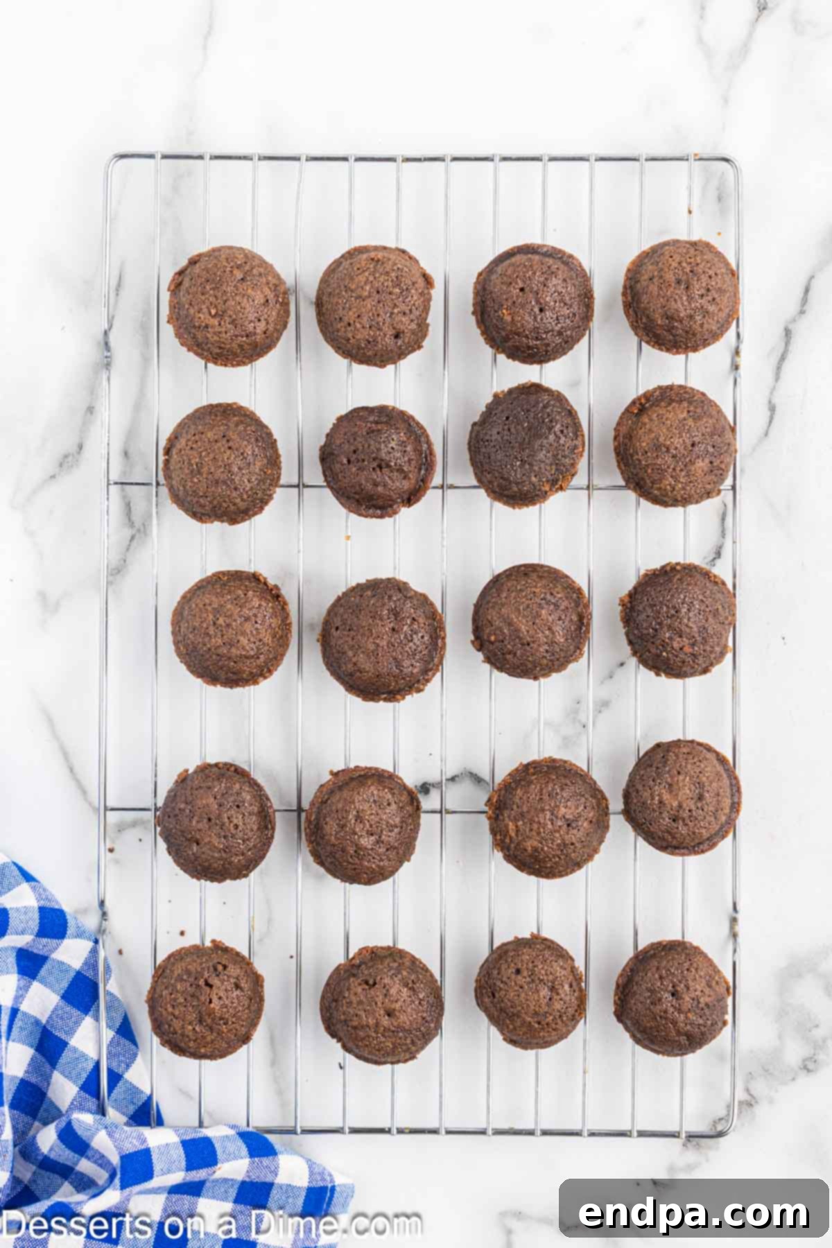 Texas Sheet Cake Minis 8 Freshly baked Texas Sheet Cake Bites cooling on a wire rack after being removed from the oven.