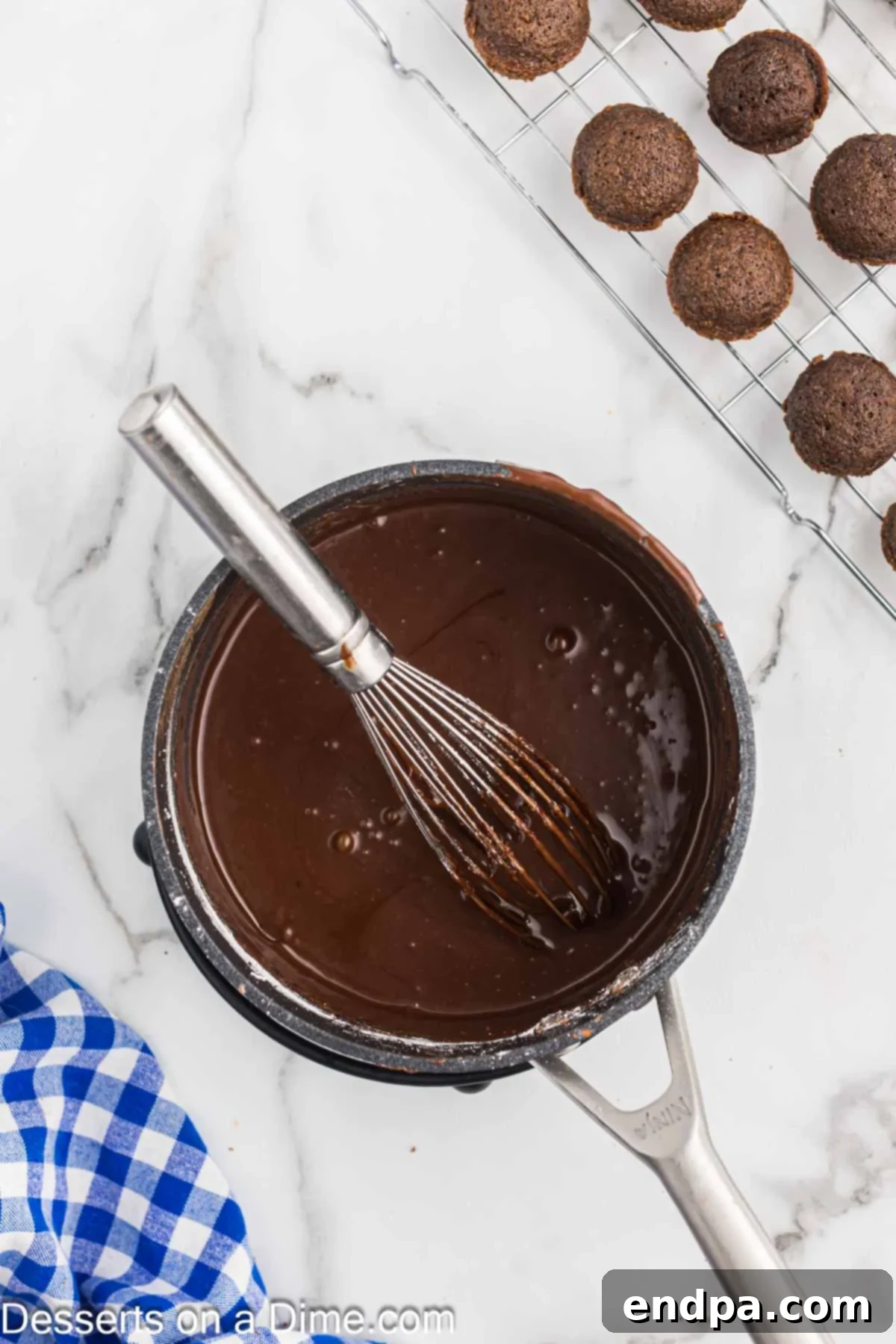Texas Sheet Cake Minis 9 A saucepan on the stove containing the ingredients for the chocolate frosting: butter, buttermilk, and cocoa powder.