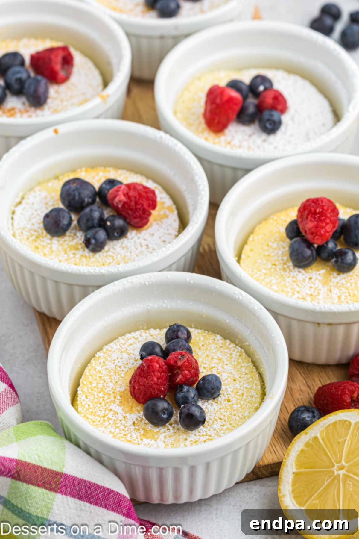 Individual lemon pudding cakes, freshly baked and golden brown in ramekins.