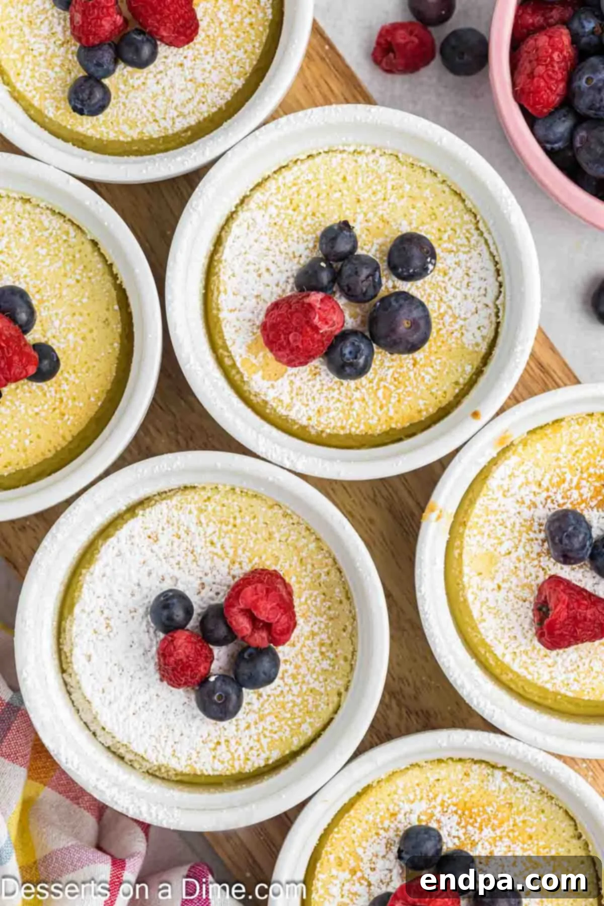 Close-up of a single lemon pudding cake in a ramekin, showing the distinct cake and pudding layers.