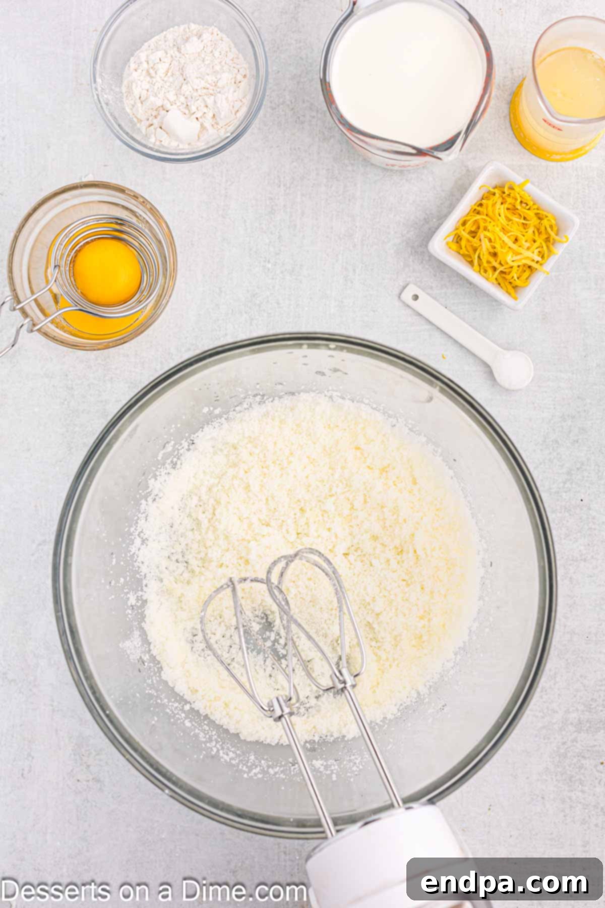 Creaming melted butter and granulated sugar in a large mixing bowl.