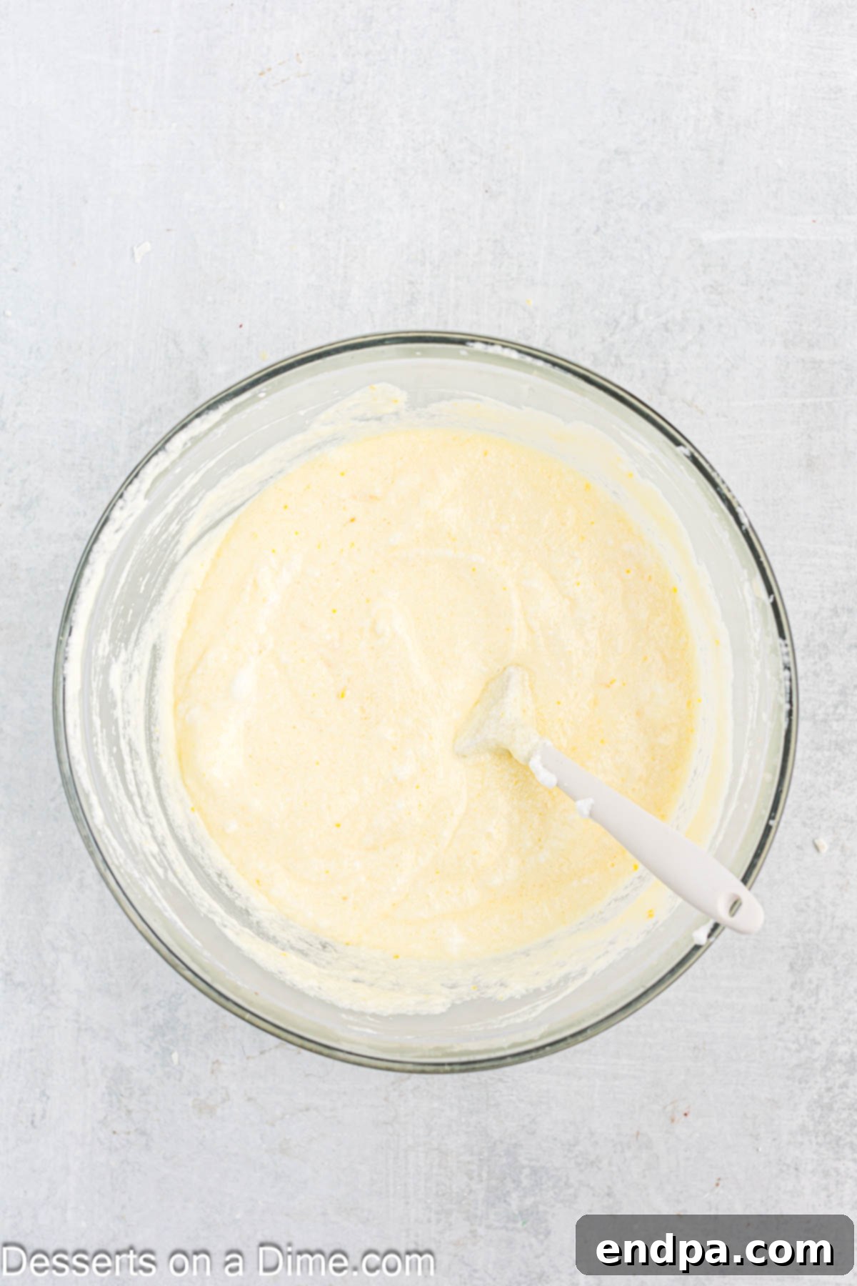 Whipping egg whites in a separate bowl until they form soft peaks.
