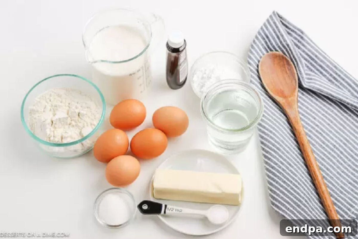 Learn how to make cream puffs at home that are bakery quality but so easy. They are so light and fluffy with the most decadent filling. Ingredients needed for cream puffs: water, butter, salt, sugar, flour, and eggs, laid out on a kitchen surface.