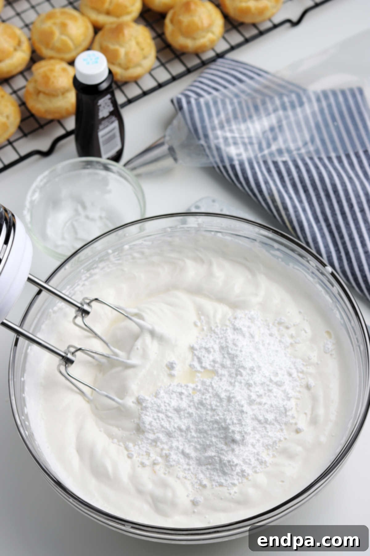 Irresistible Cream Puffs 6 Mixing bowl with cream filling ingredients combined together, showing a light and airy texture.