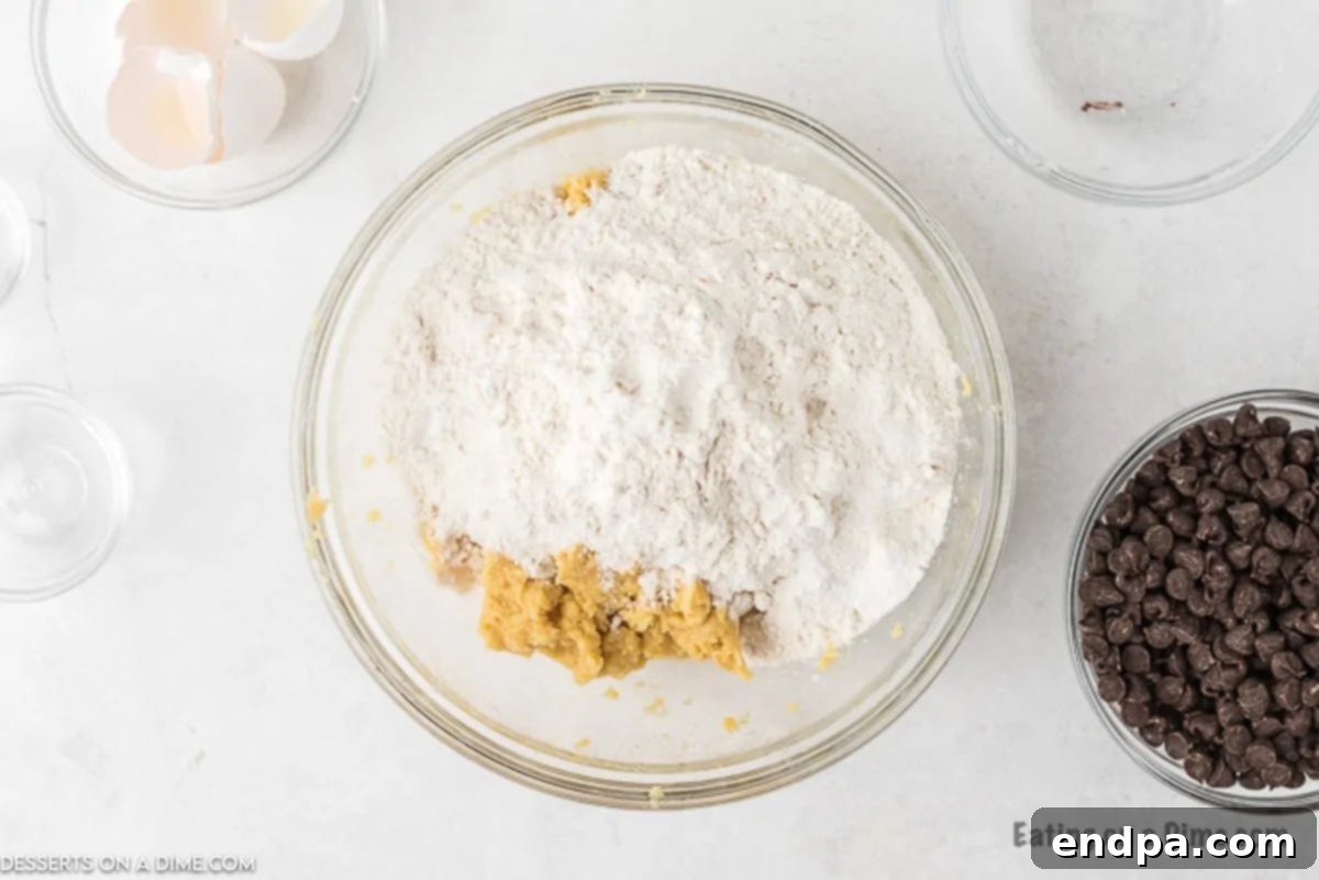 Dry ingredients including flour, salt, and baking soda being mixed into the wet ingredients in a bowl.