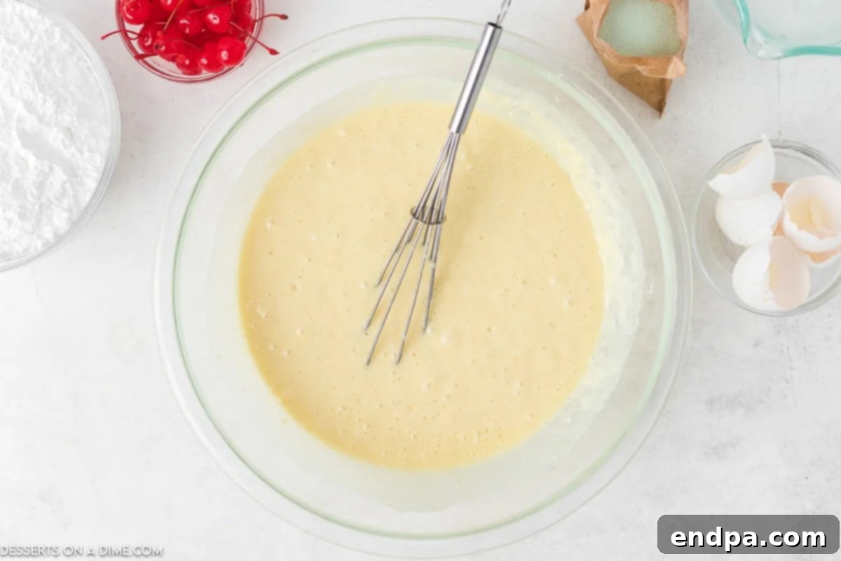 Zingy Cherry Limeade Cupcakes 2 A mixing bowl filled with light green cupcake batter, smooth and ready to be scooped into cupcake liners for baking.