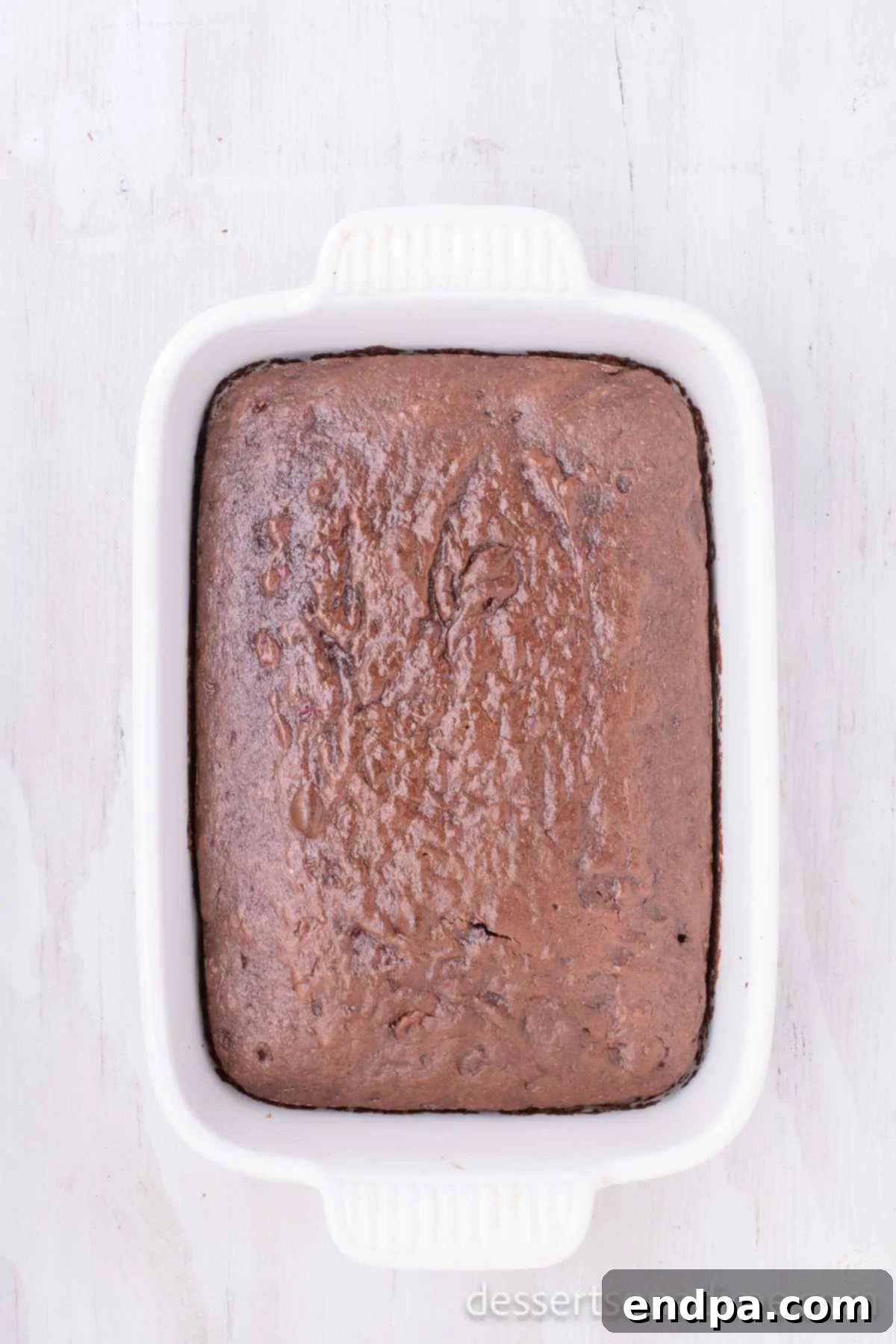 Decadent Chocolate Cherry Delight 4 The chocolate cherry cake baking in the oven, showing its rising texture and rich color, almost ready to be removed.