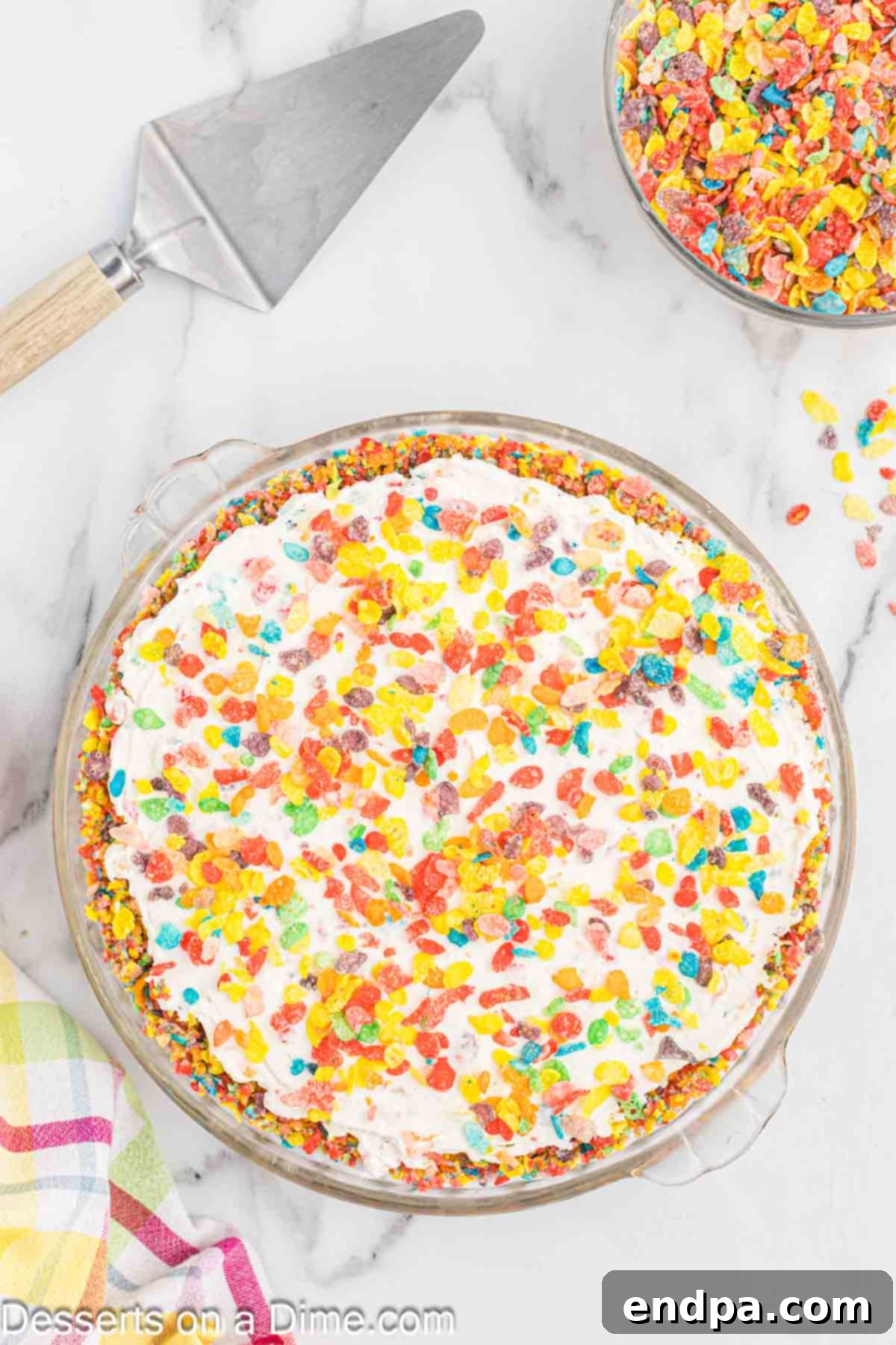 Vibrant Fruity Pebbles Cheesecake 9 Additional Fruity Pebbles cereal generously sprinkled over the top of the chilled cheesecake, adding a final touch of color and crunch.