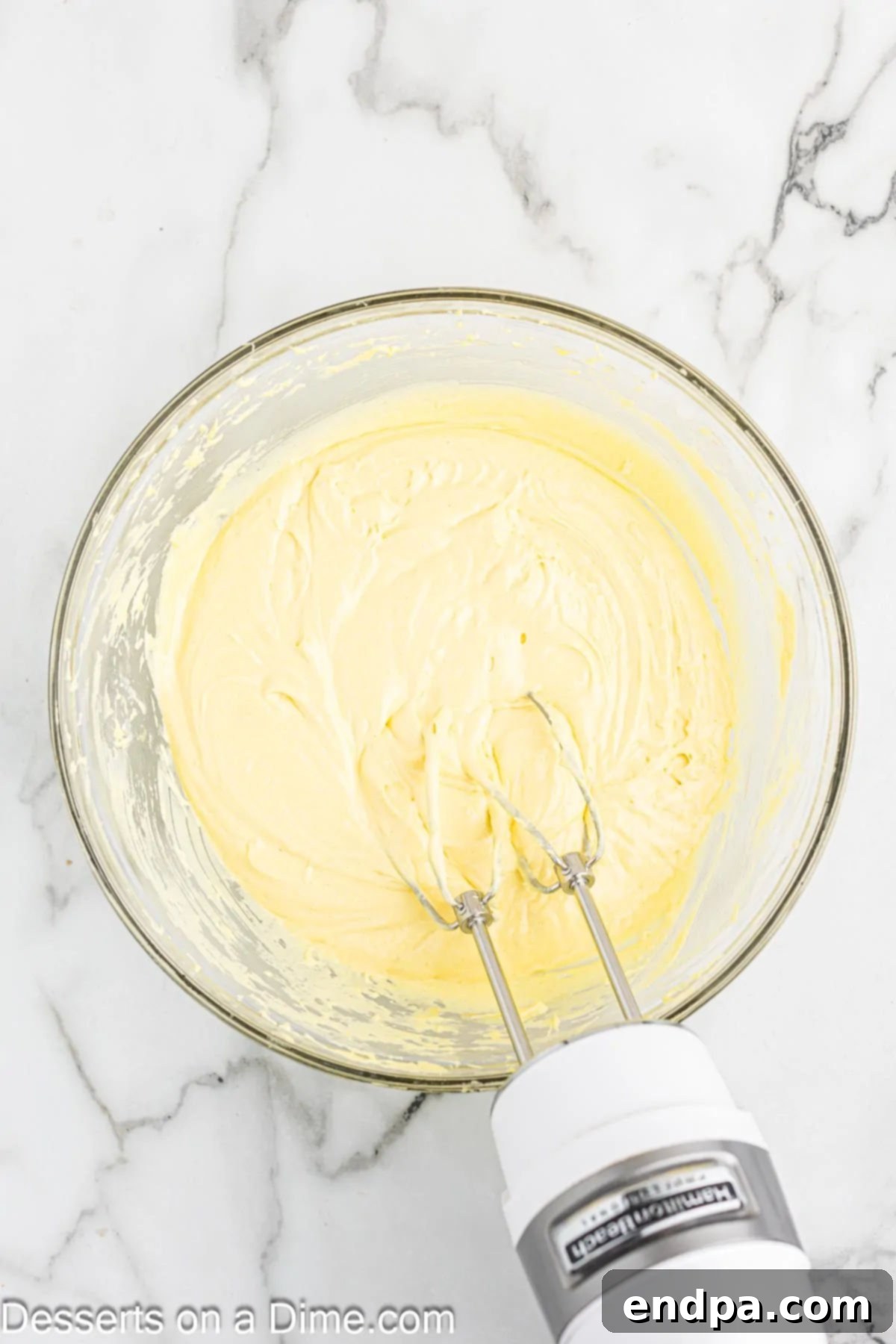 Mixing cake mix, pudding, and eggs in a large bowl.