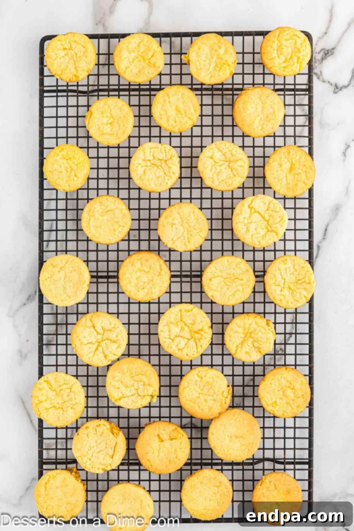 Baked Lemon Blossoms cooling on a wire rack.