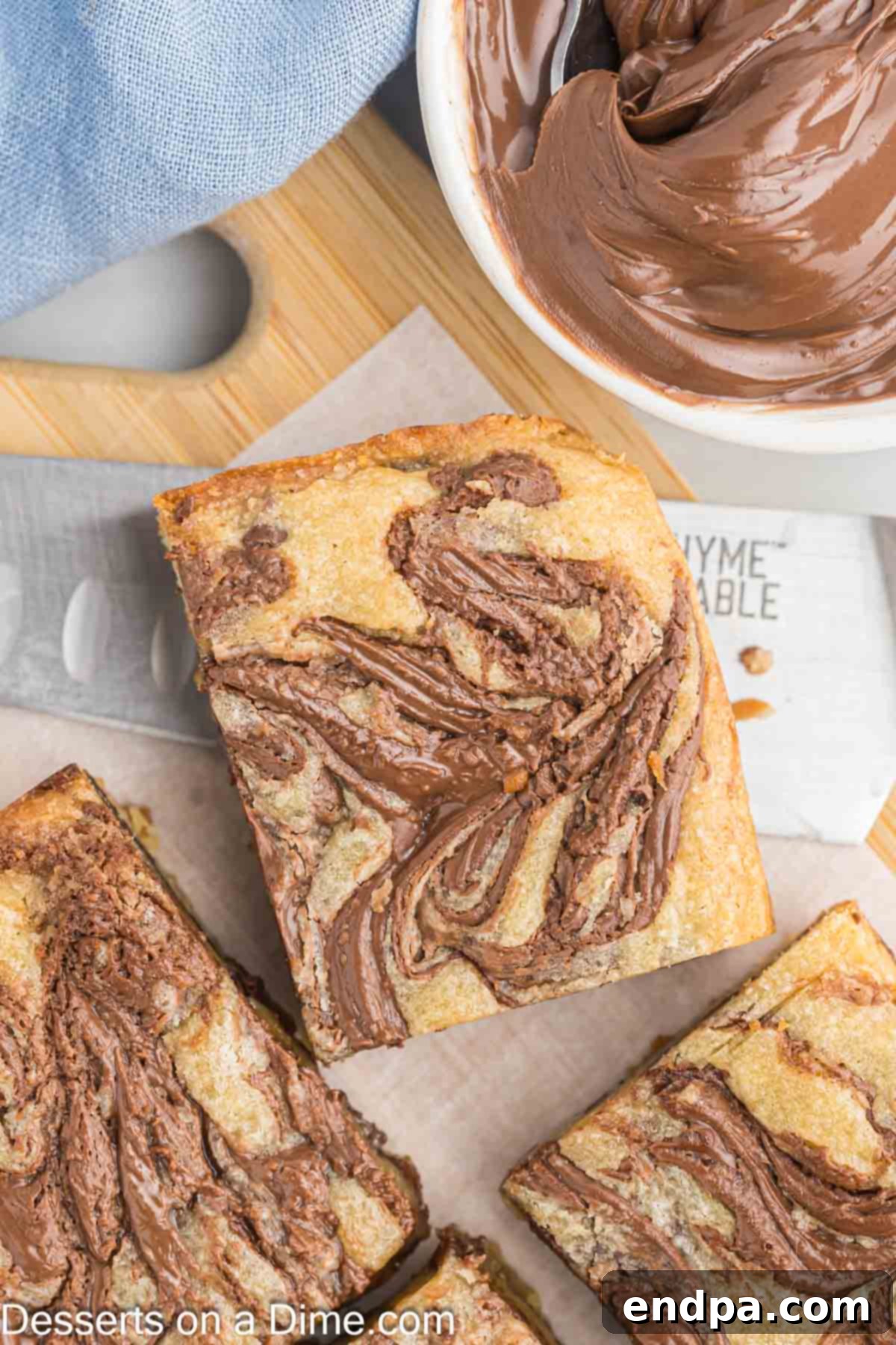 Decadent Nutella Bars 2 Nutella Bars cut into perfect squares, showcasing the chocolate chips and Nutella swirls.