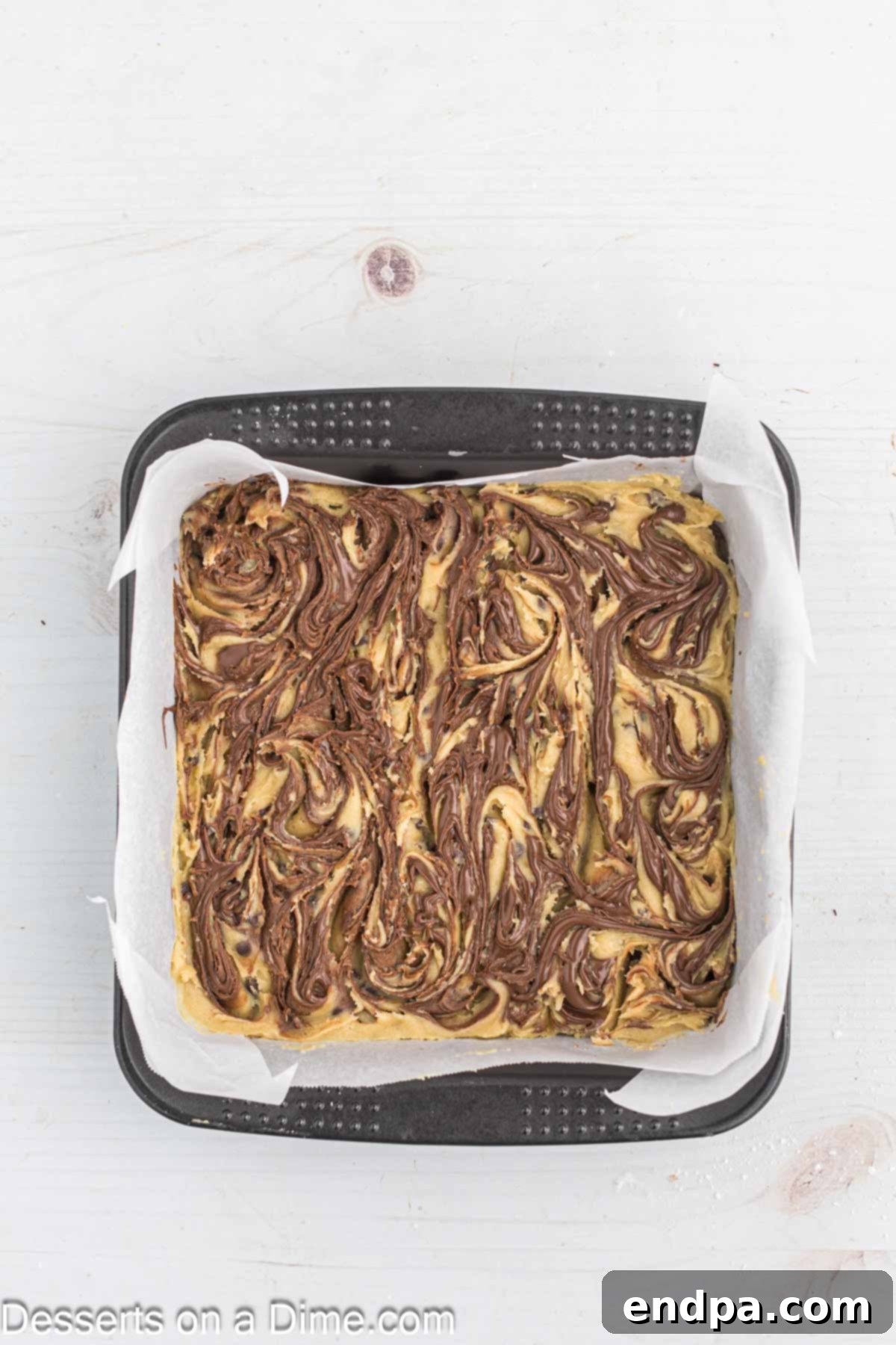 Decadent Nutella Bars 11 A knife swirling the Nutella and cookie dough together to create an attractive pattern.