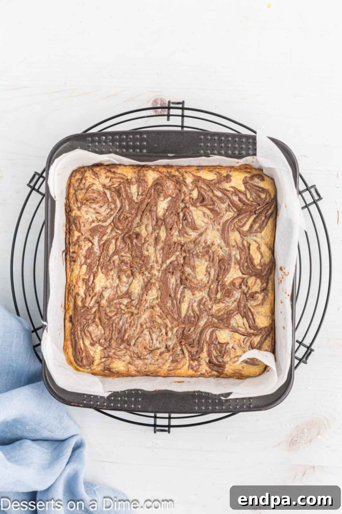 Decadent Nutella Bars 12 Baked Nutella Bars cooling on a wire rack in the pan.