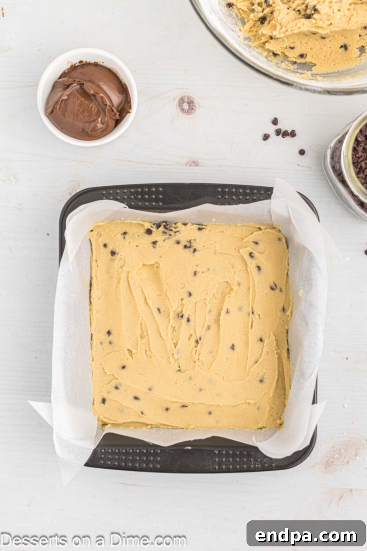 Decadent Nutella Bars 8 Half of the cookie dough batter pressed into the bottom of the prepared baking pan.